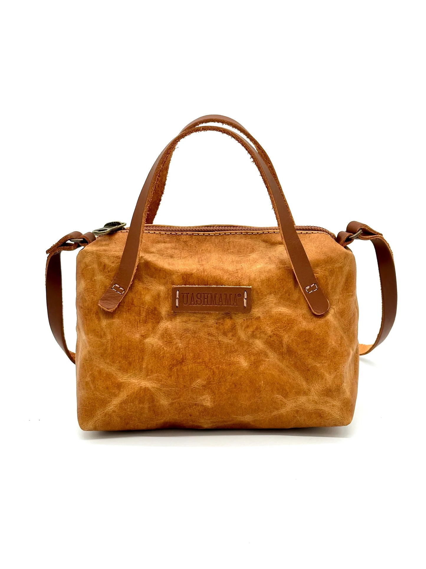Front view of The Gemmina Bag in tan, featuring vegetable-tanned leather handles, a secure zipper closure, and a compact, stylish design, perfect for daily essentials