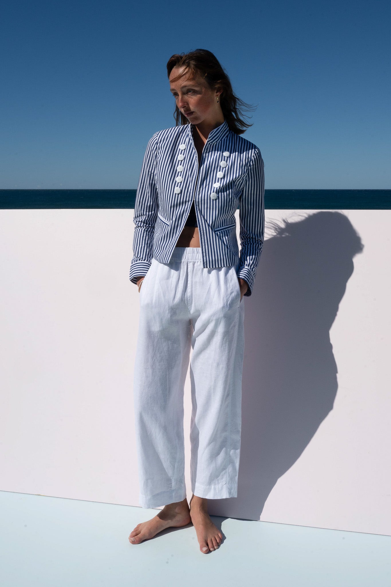Abbey Road Jacket in cotton poplin azure stripe, front view with model hands in pockets.