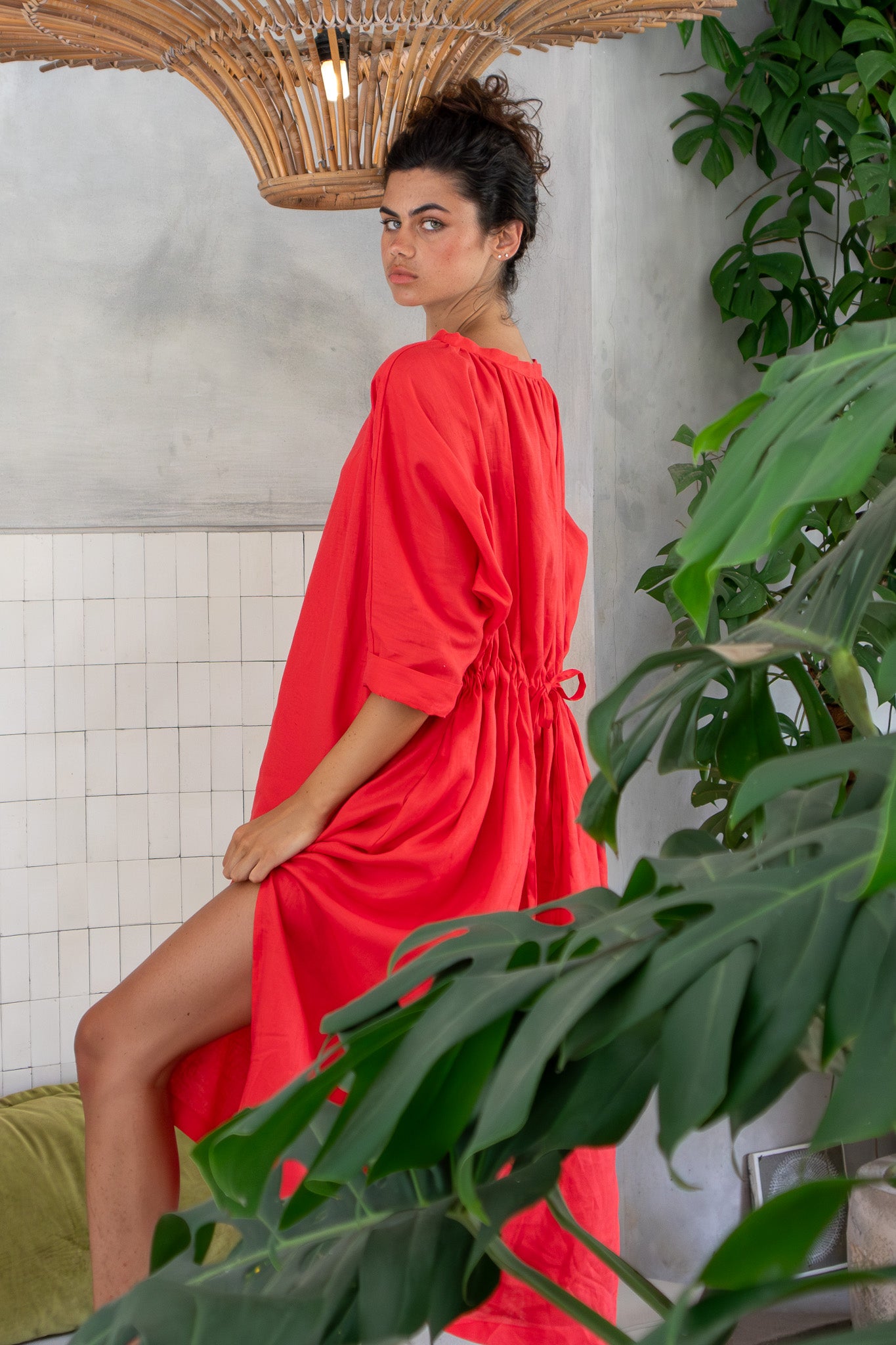 Beautiful model wearing red linen dress from designer label 