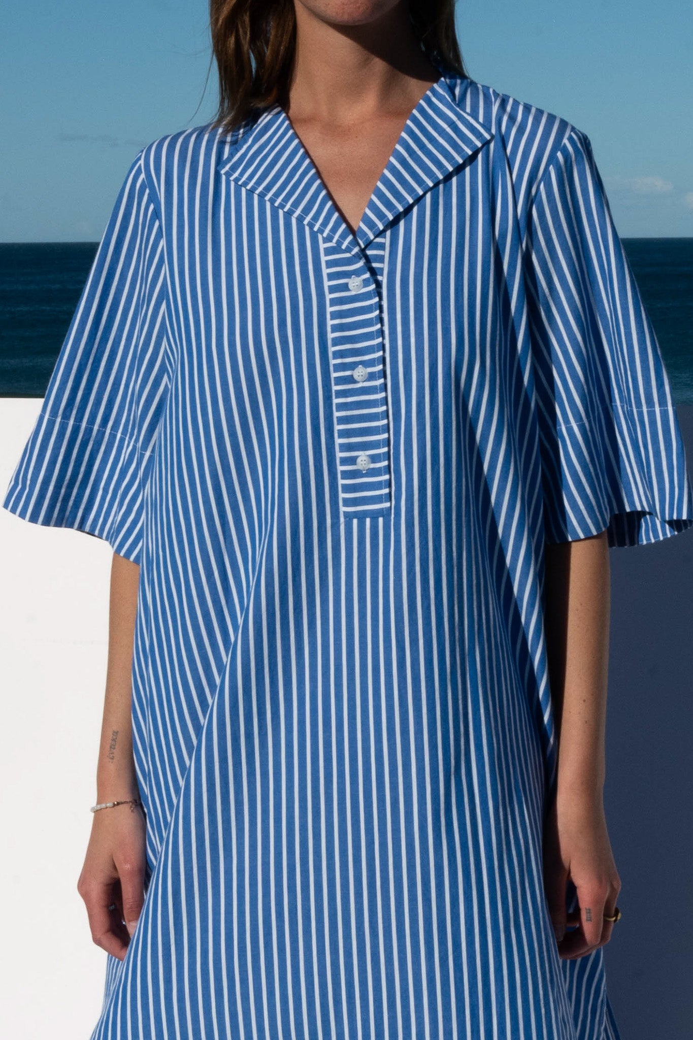 Close-up of button placket and collar detail on the Cabana Dress in blue stripe