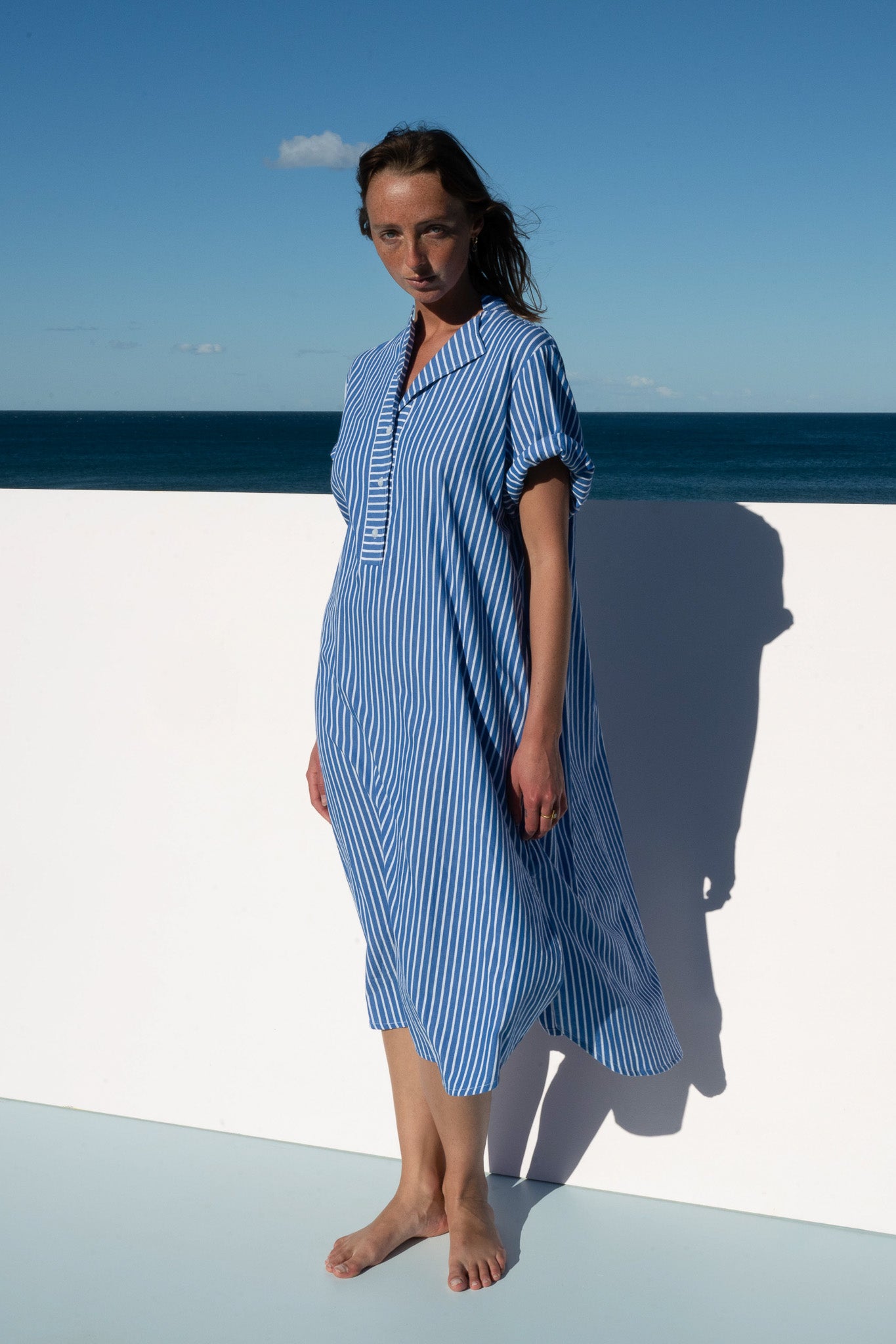 Full-length view of the Cabana Dress in cotton blue stripe, oversized and relaxed silhouette.
