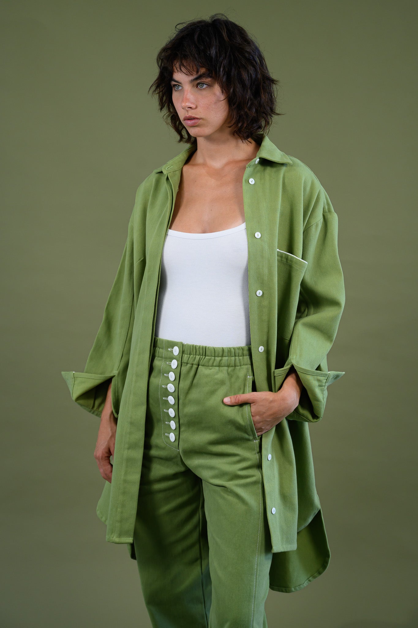 Womens field green canvas denim jacket mid length detail showing relaxed fit fabric and button front