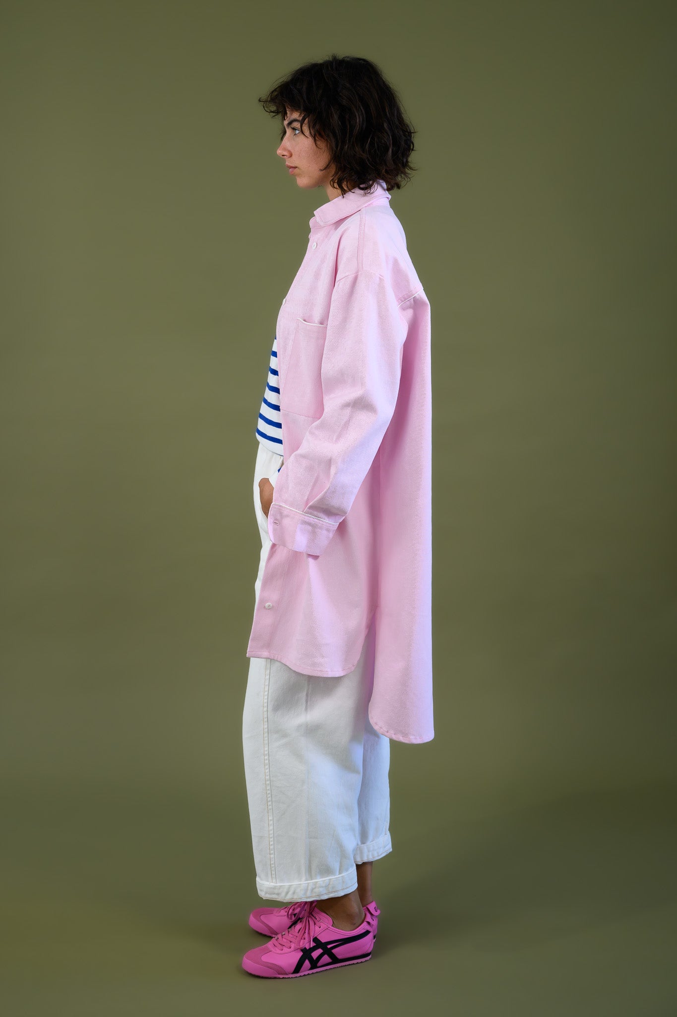 Womens pink canvas denim jacket side profile showing length and relaxed fit with white pants