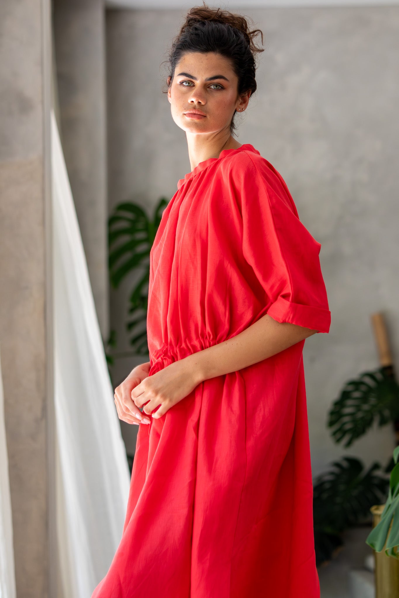 Side angel of the moments dress one size fit adjustable waist in red linen 