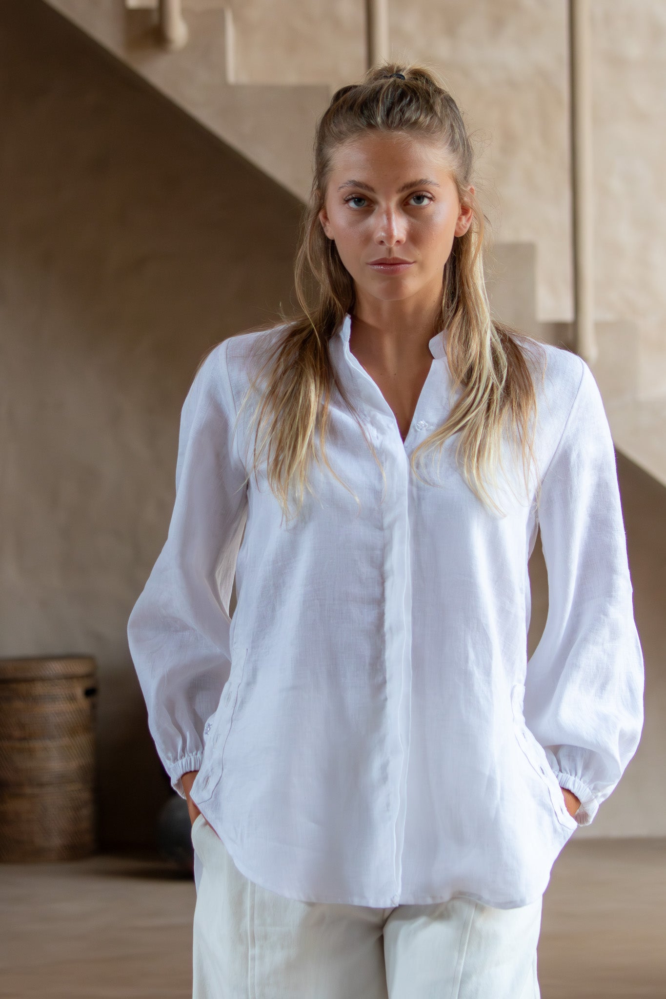 Close-up of the Coconut Blouse in white, focusing on the collar and elastic cuff design in natural linen.