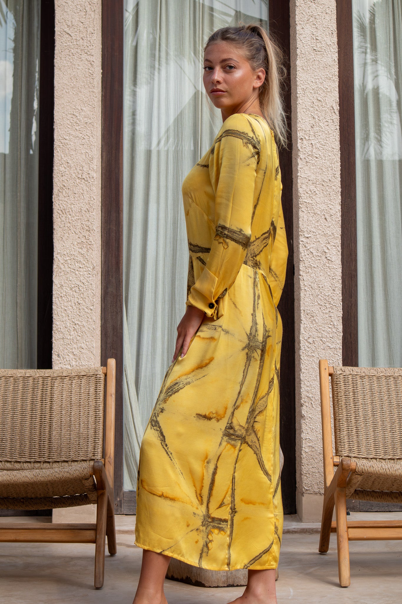 Close-up of model in Mango Shibori Maggie Dress showing organic tie-dye pattern