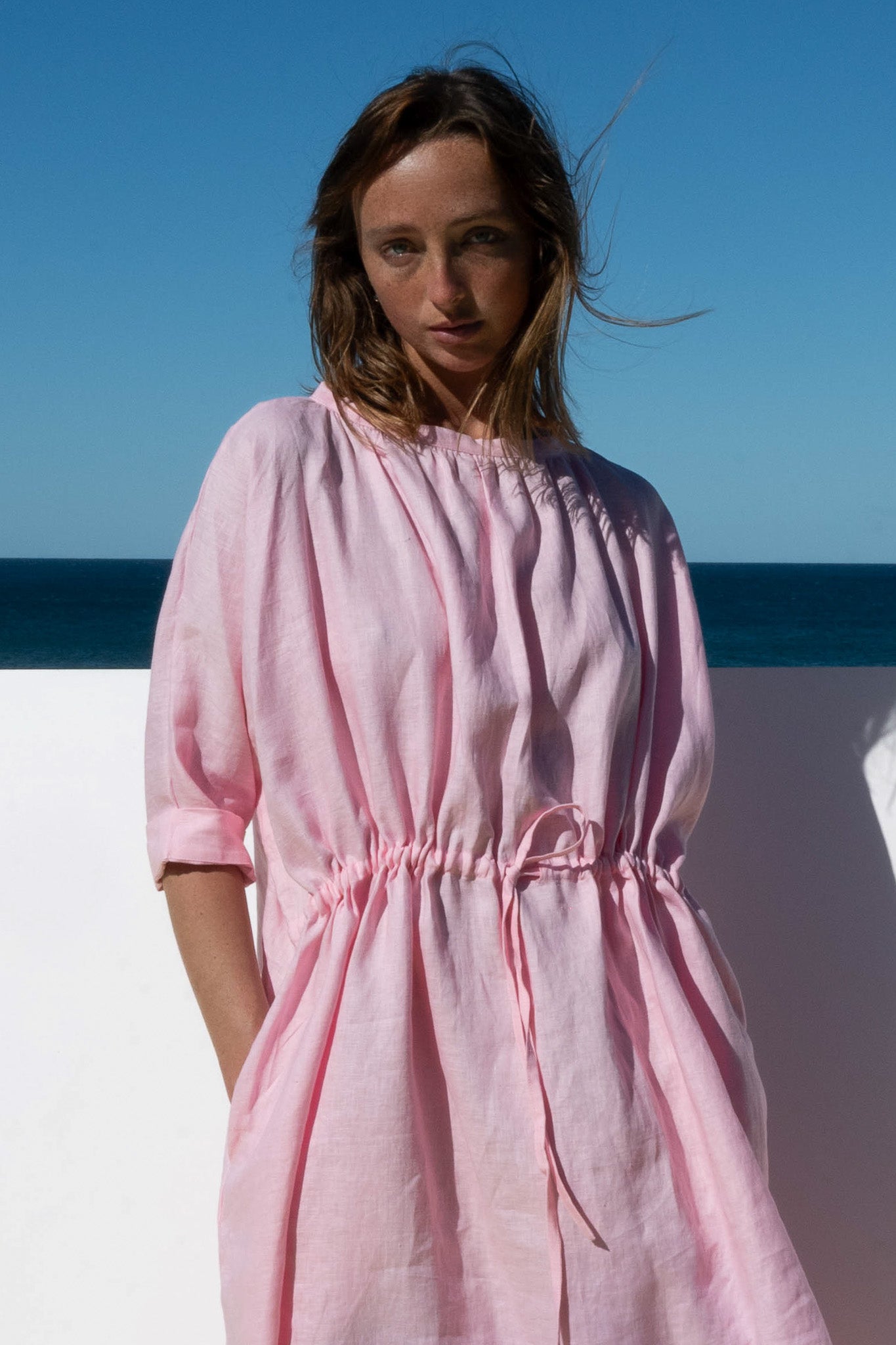 Close-up of The Moments Dress in Bonbon Pink, showing gathered neckline and cinched waist detail.