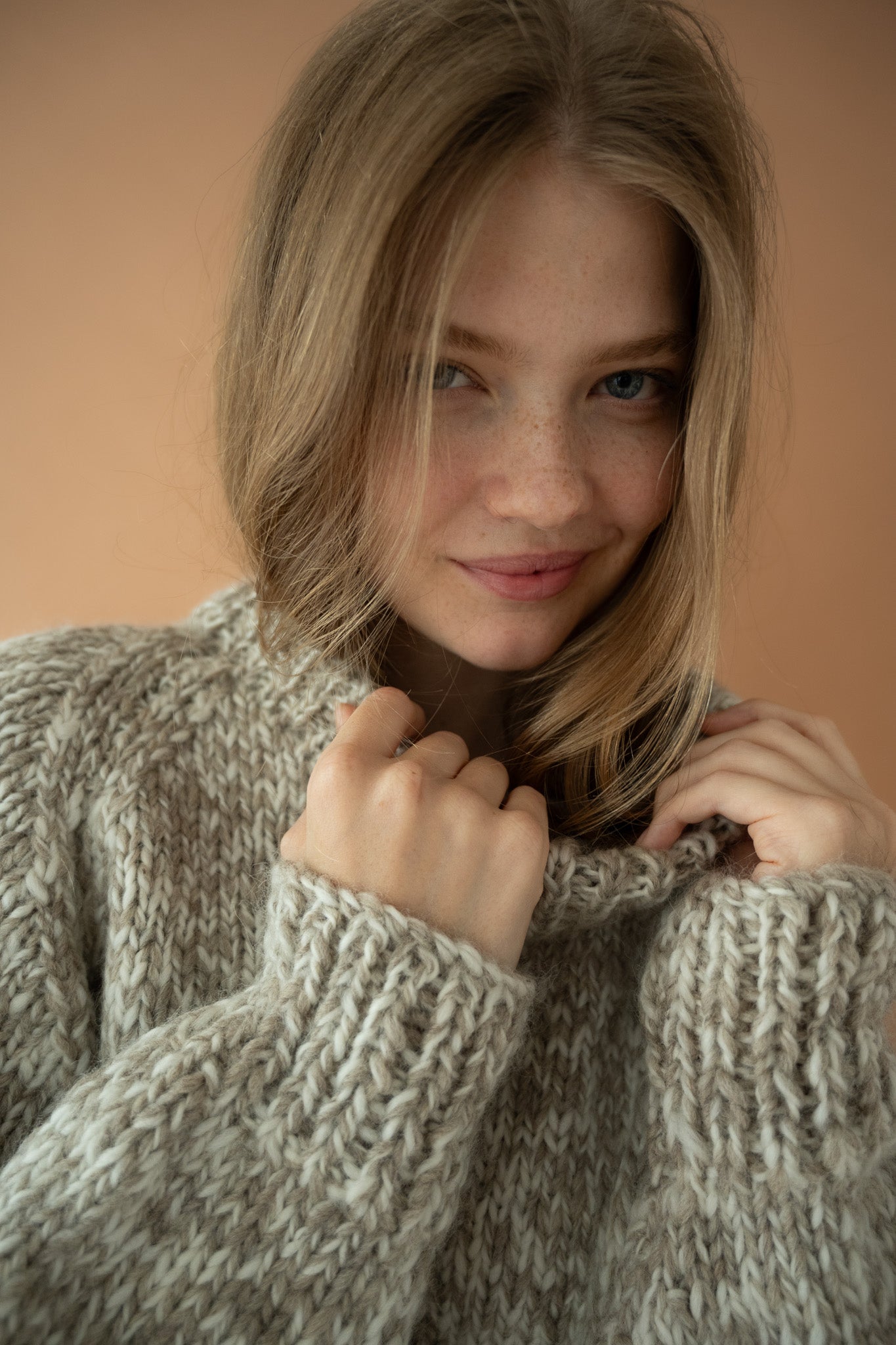 Detail shot of The Boy & I Nordic Knit in flecked natural wool with thick ribbed sleeves and collar