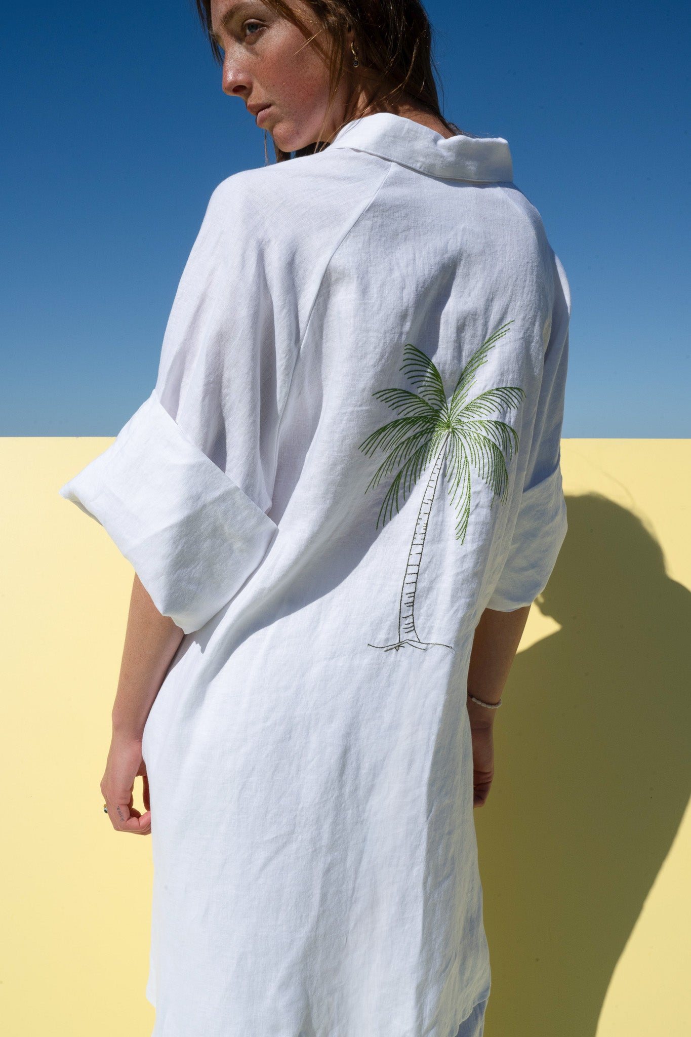 Oceanic Shirt Dress in white linen – close-up back detail with embroidered palm tree