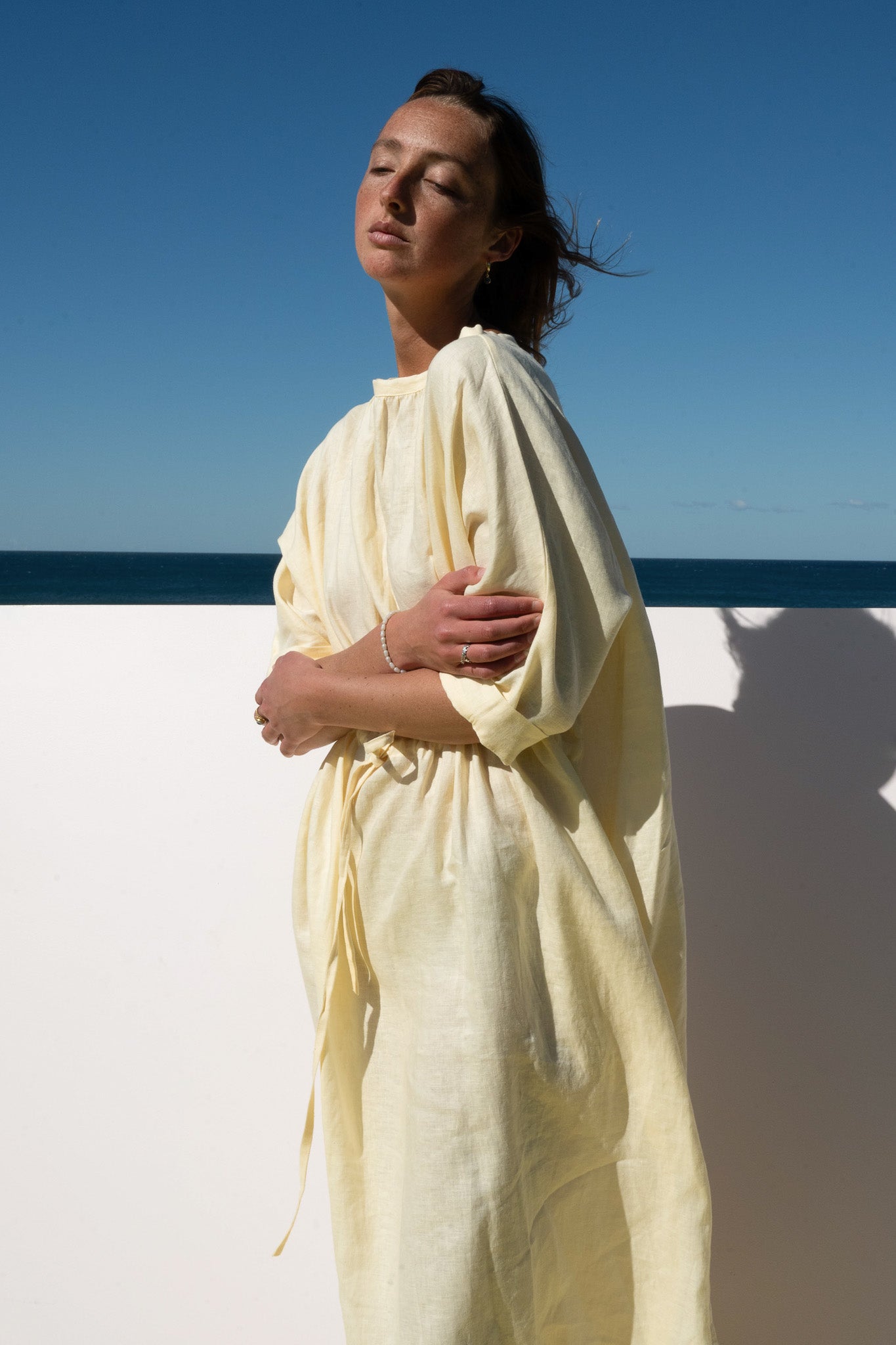 The Moments Dress in yellow linen – front view with gathered waist and relaxed silhouette