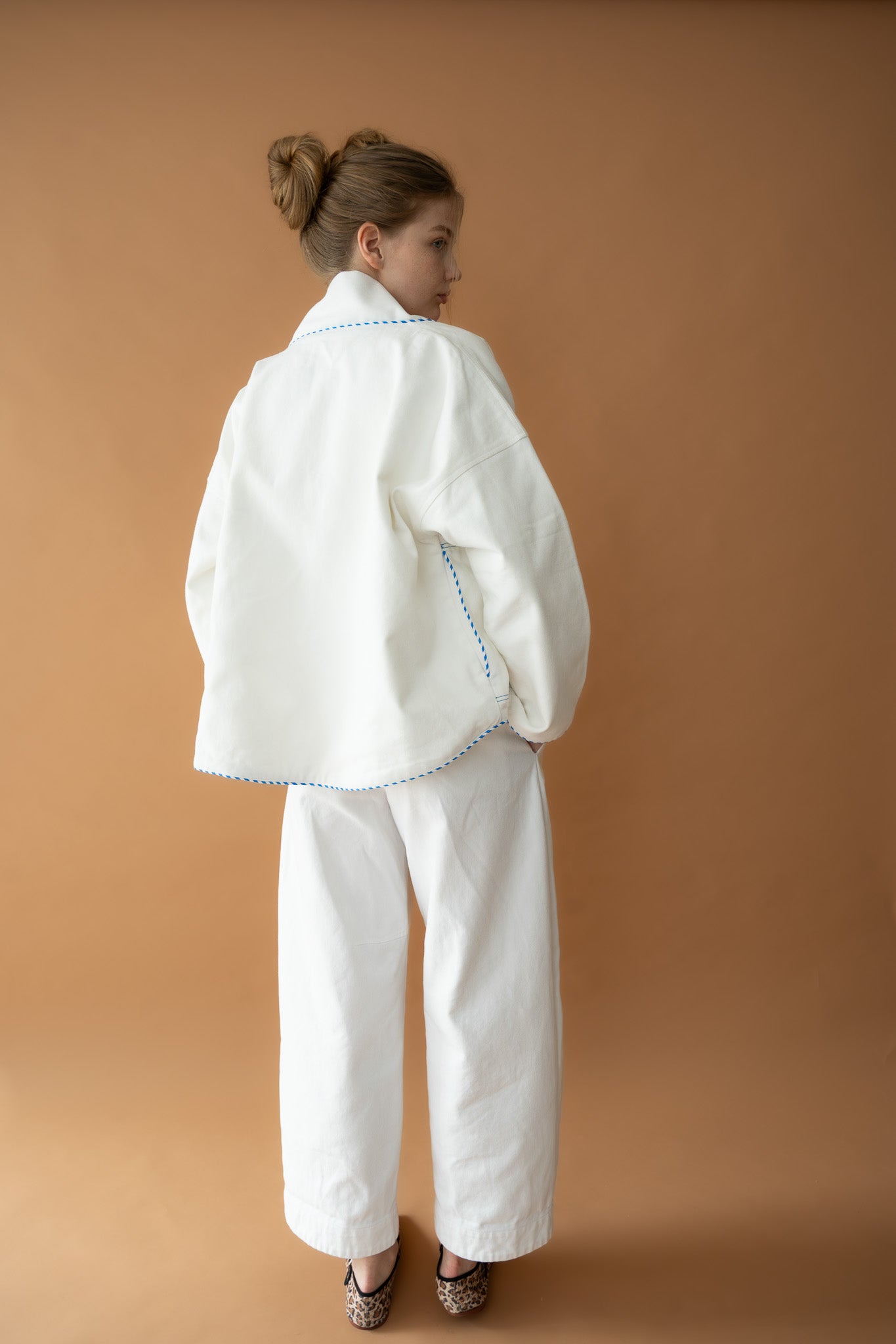 Back view of Yoko Kimono Shortie in Vanilla Stripe showcasing blue piping detail