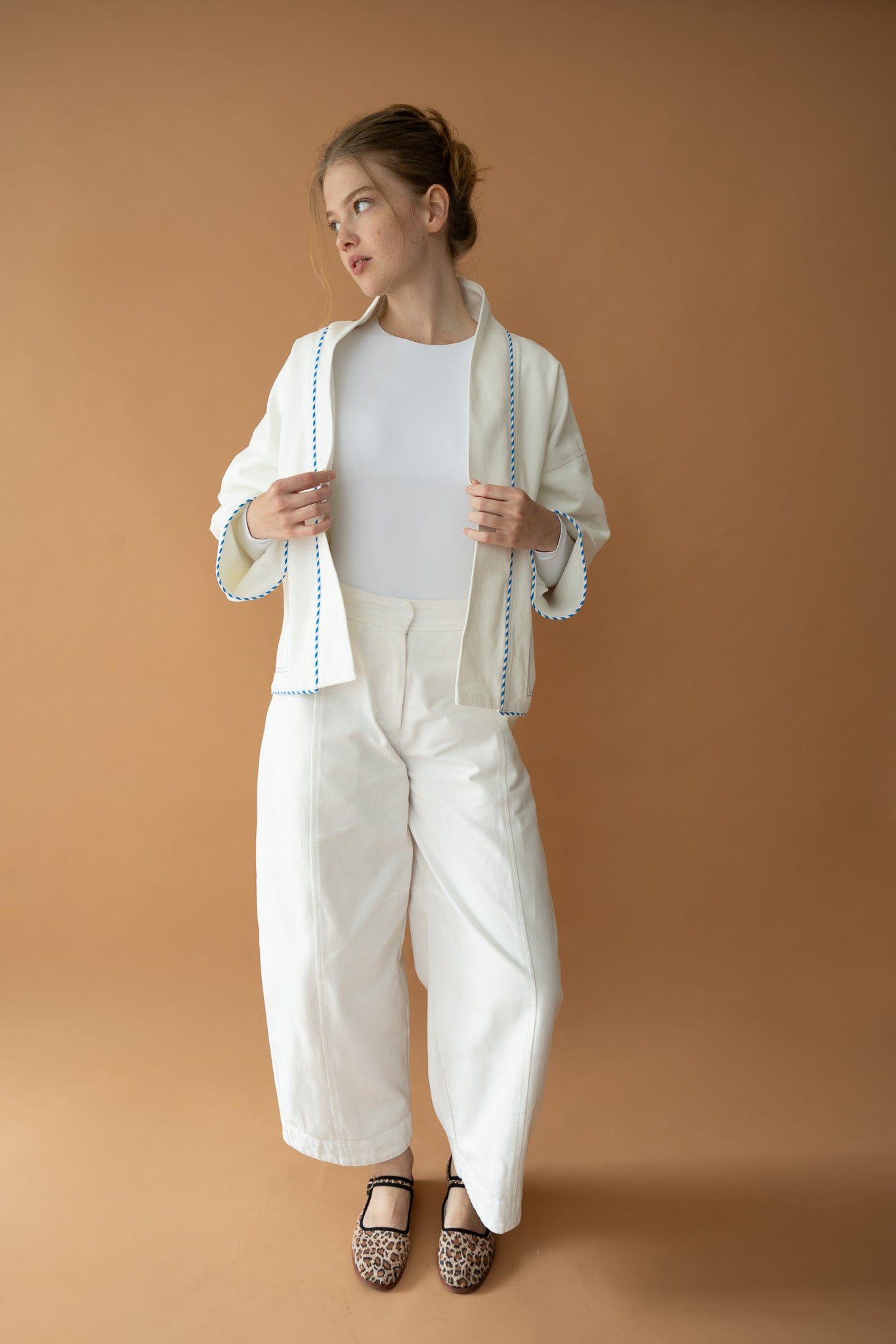 Model wearing Yoko Kimono Shortie in Vanilla Stripe open over matching white set, front view