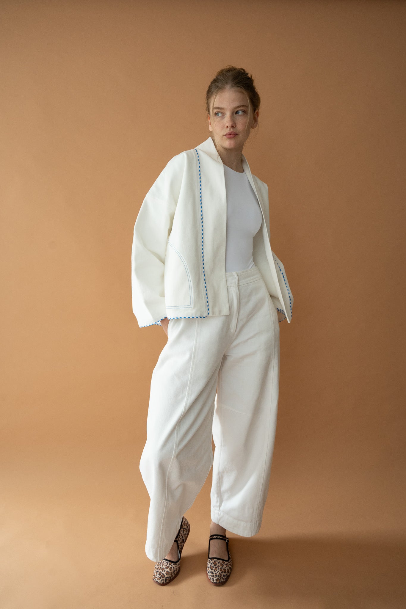 Model standing in Yoko Kimono Shortie in Vanilla Stripe with hands in pockets