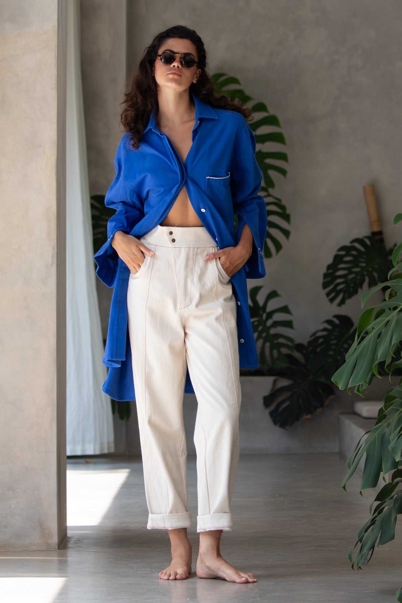 hands in pockets showing open coat look of the denim blue jacket 