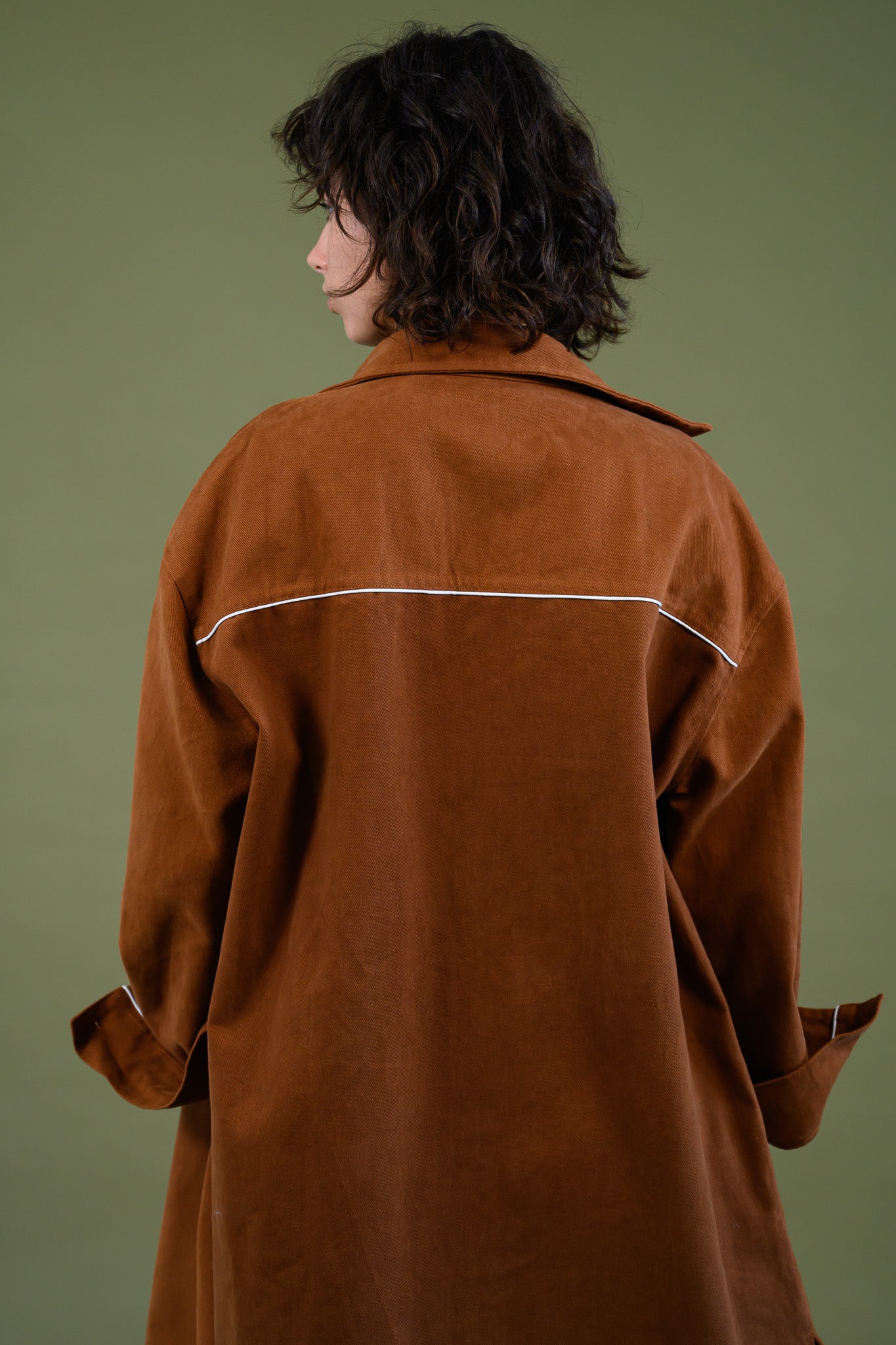 Back view of caramel cotton canvas denim shirt coat showing length and structure