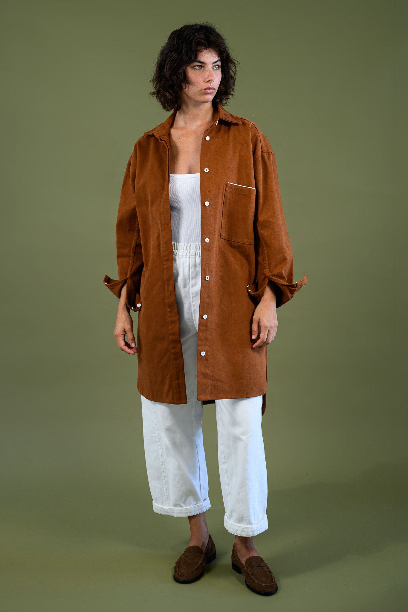 Front full body view of Caramel cotton canvas denim shirt coat worn open over white outfit
