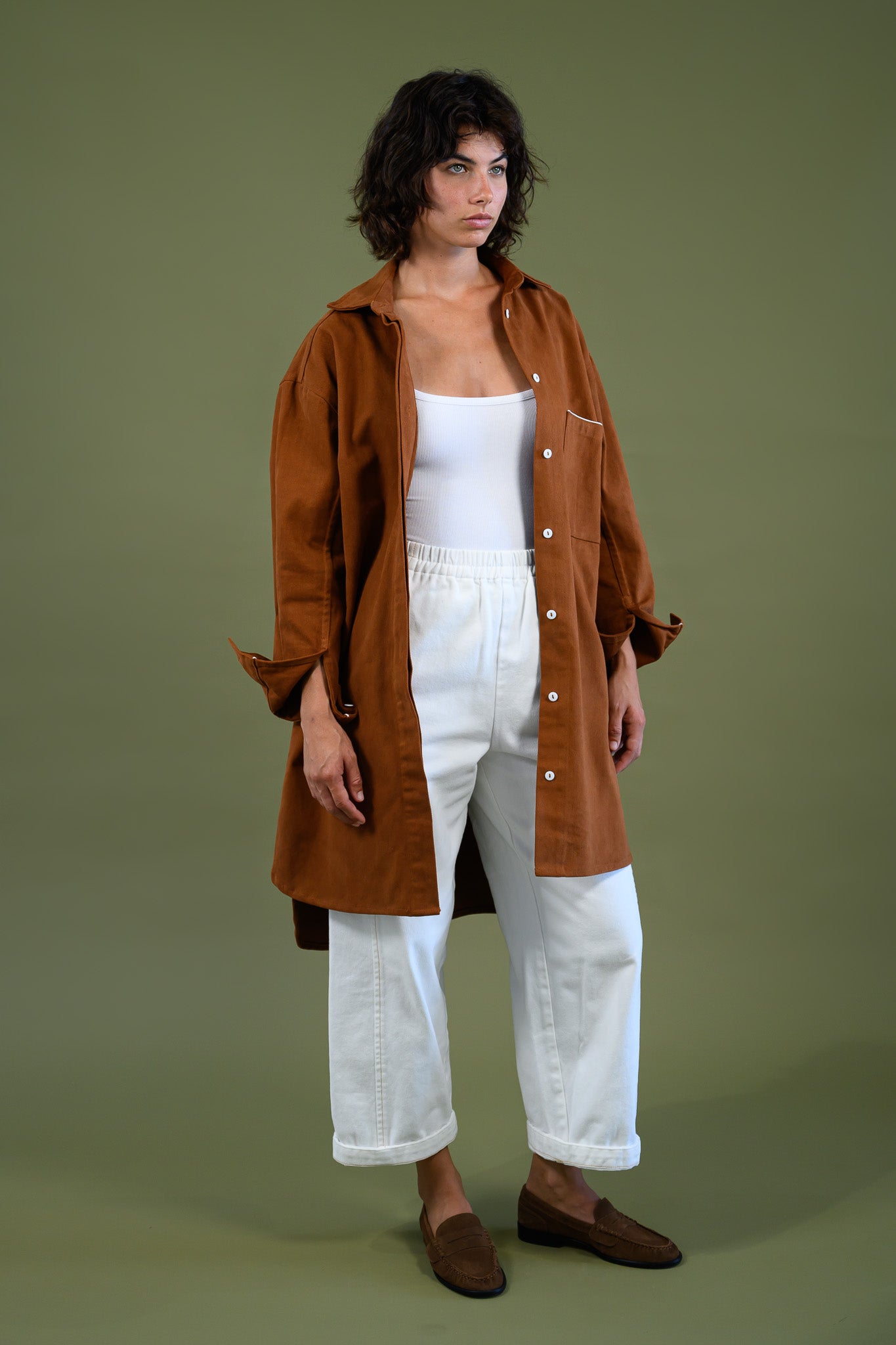Full body front view of Caramel cotton canvas denim shirt coat worn open over white outfit