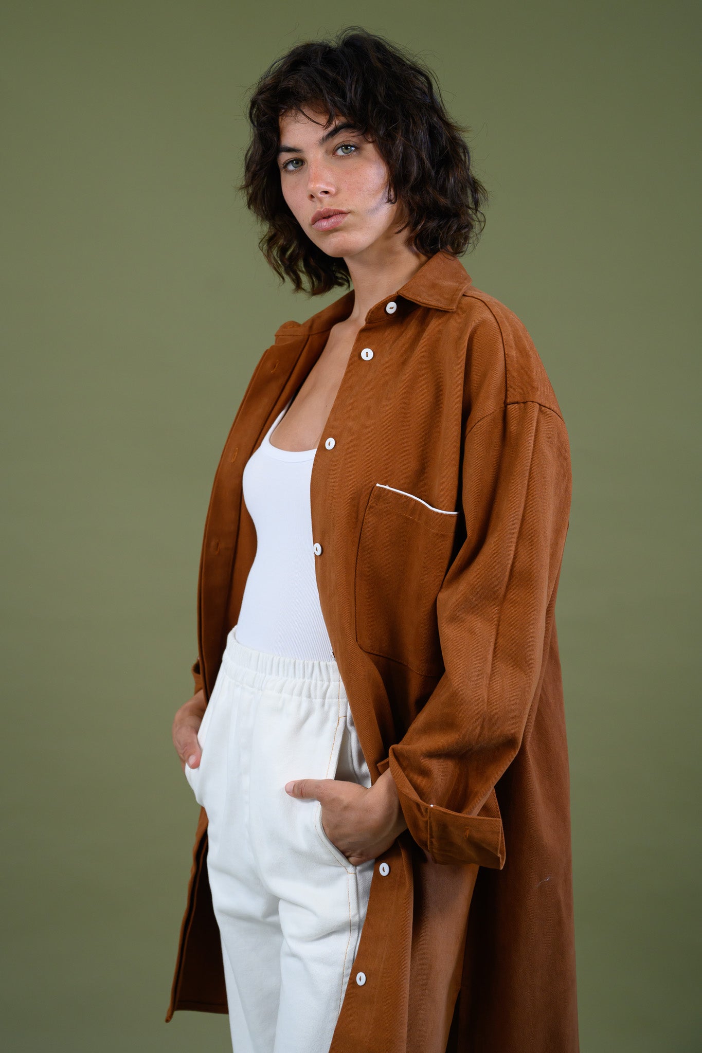 Angled front view of rCaramel  cotton canvas denim shirt coat worn open