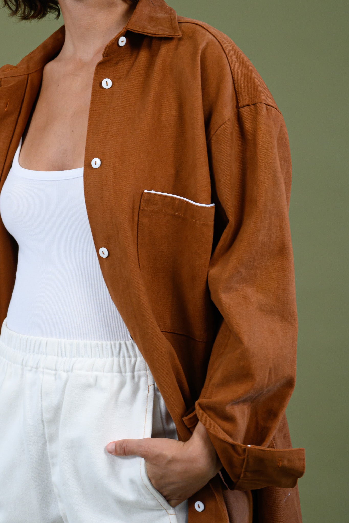 Front detail of Caramel  cotton canvas denim shirt coat showing buttons and binding
