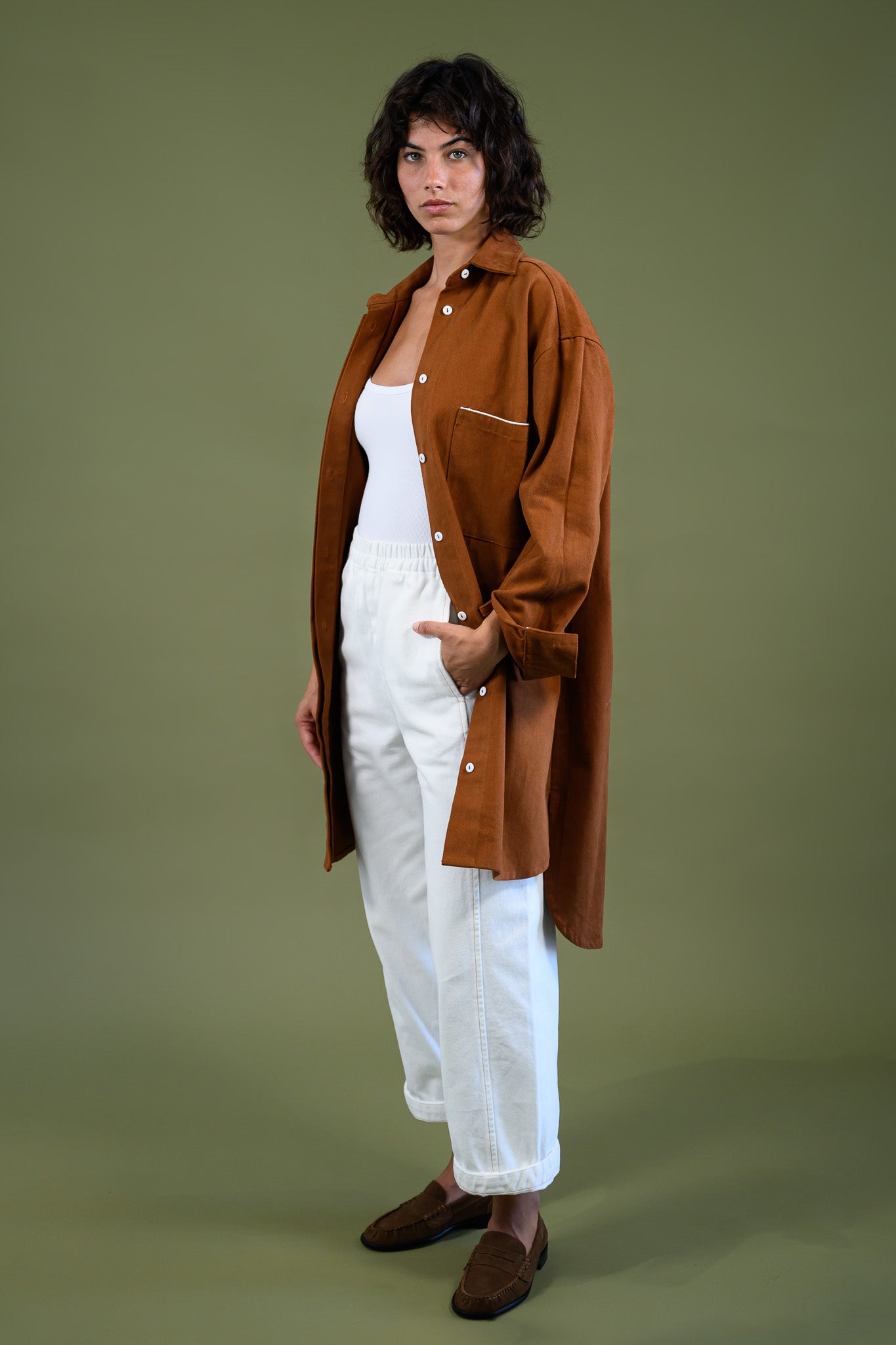 Caramel  cotton canvas denim shirt coat styled with white outfit shown full body