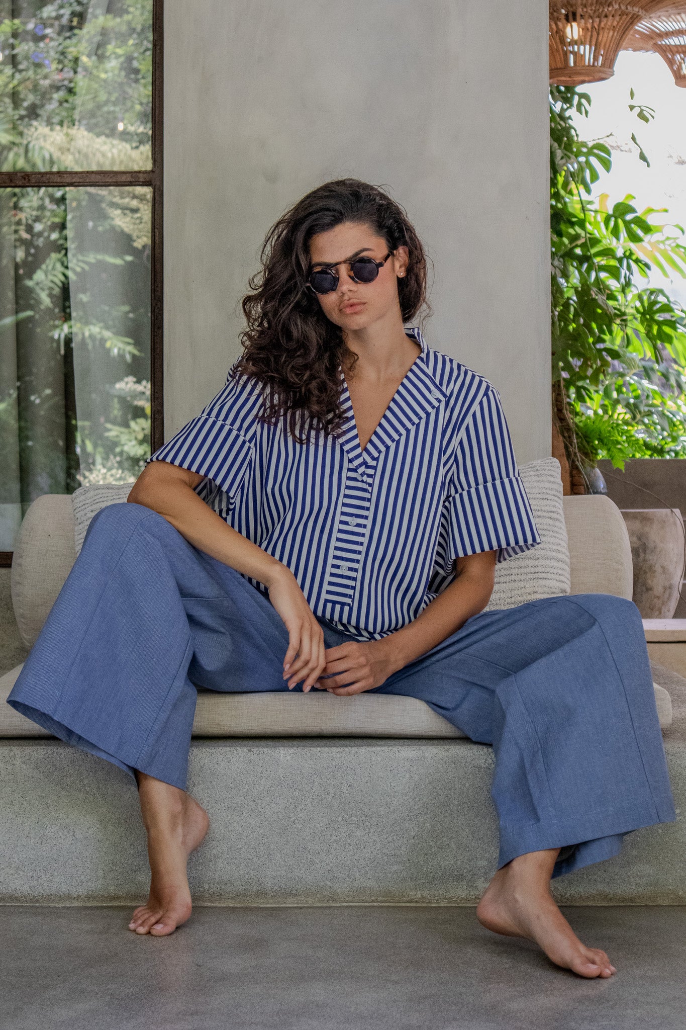 Sitting down model wearing cotton poplin blouse, made in Australia 