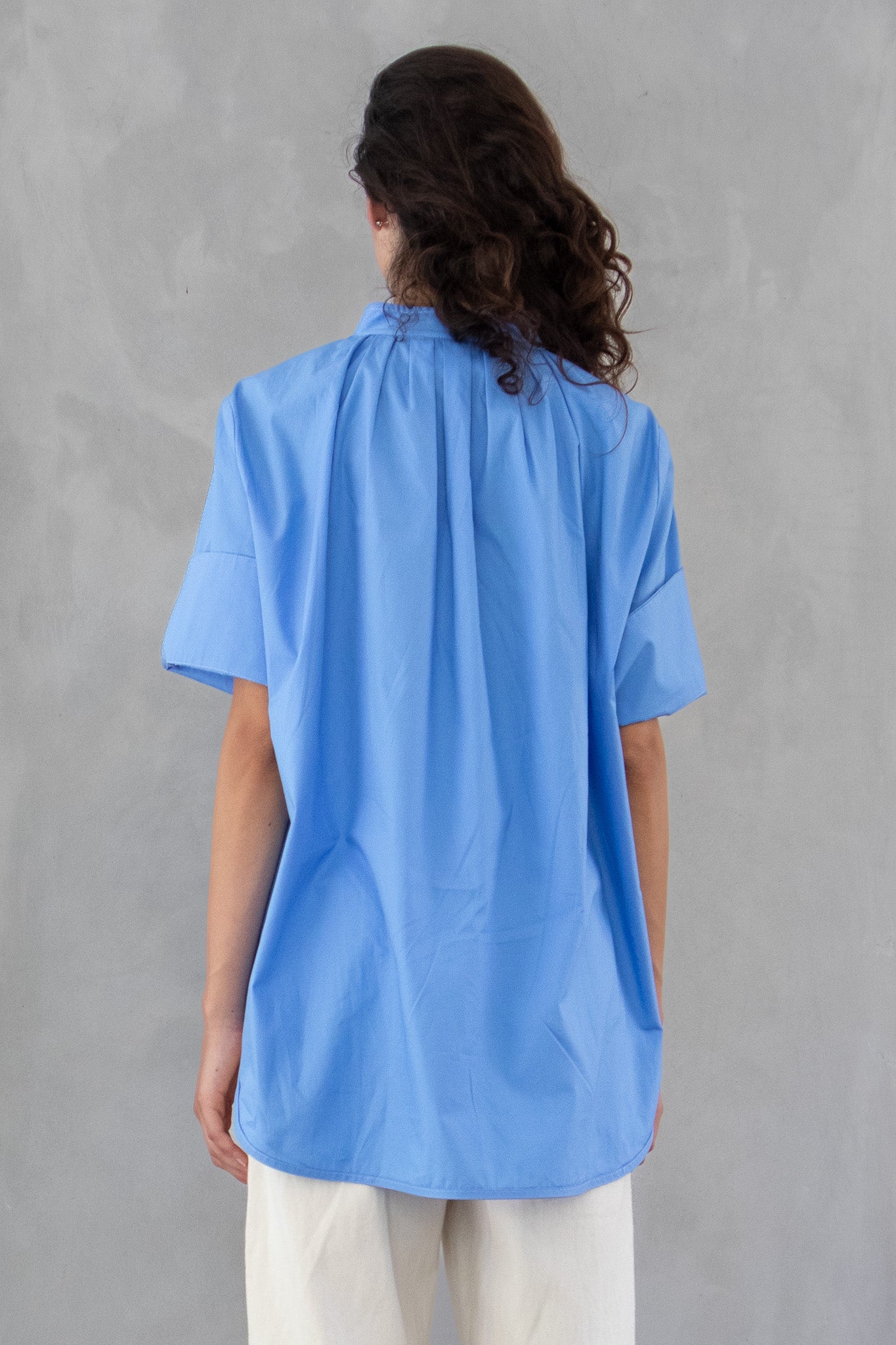 close up of the back of blue cotton poplin blouse shirt 