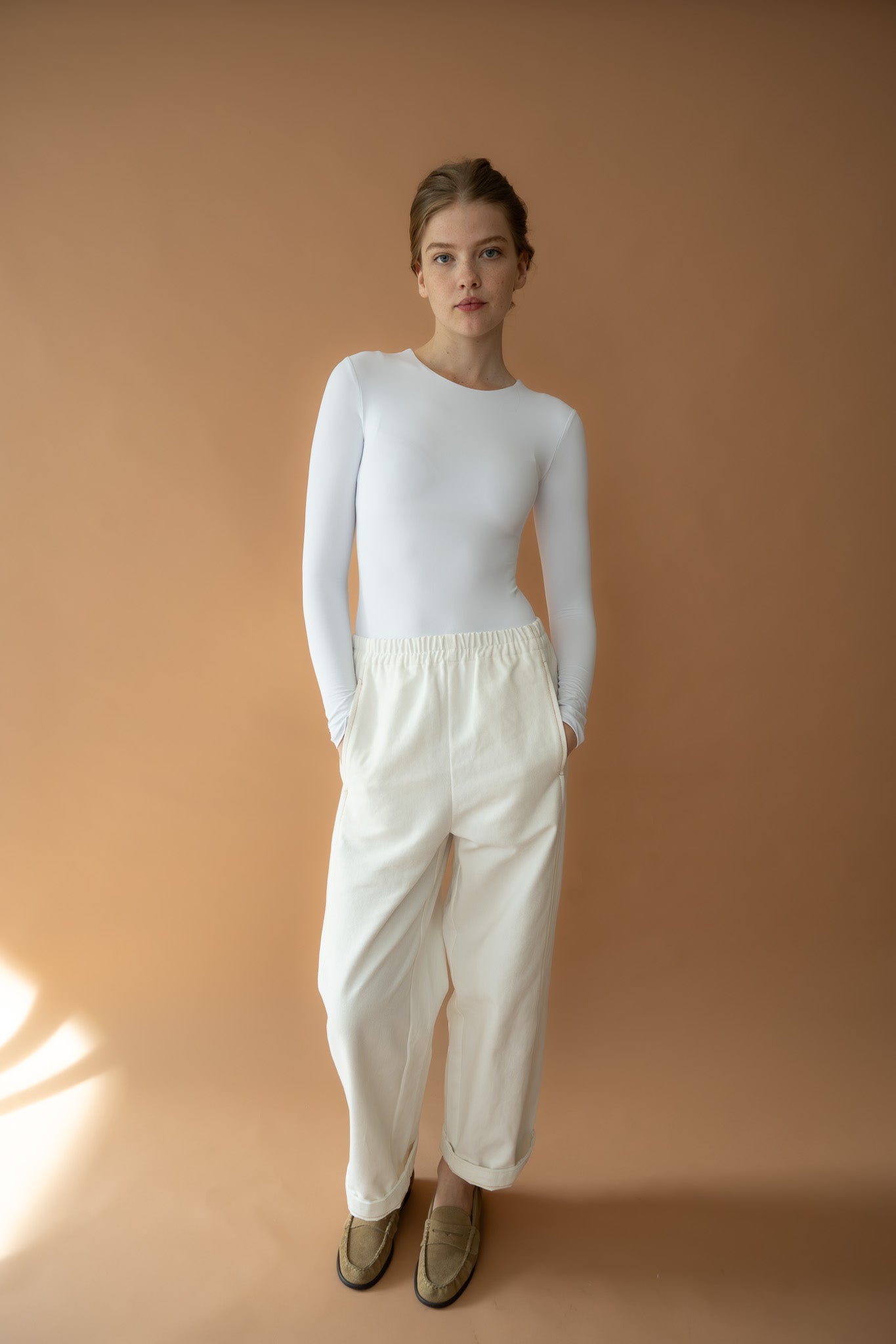 Model wearing The Boy & I Blaze Jogger in vanilla organic cotton twill, front view with relaxed fit and elastic waist