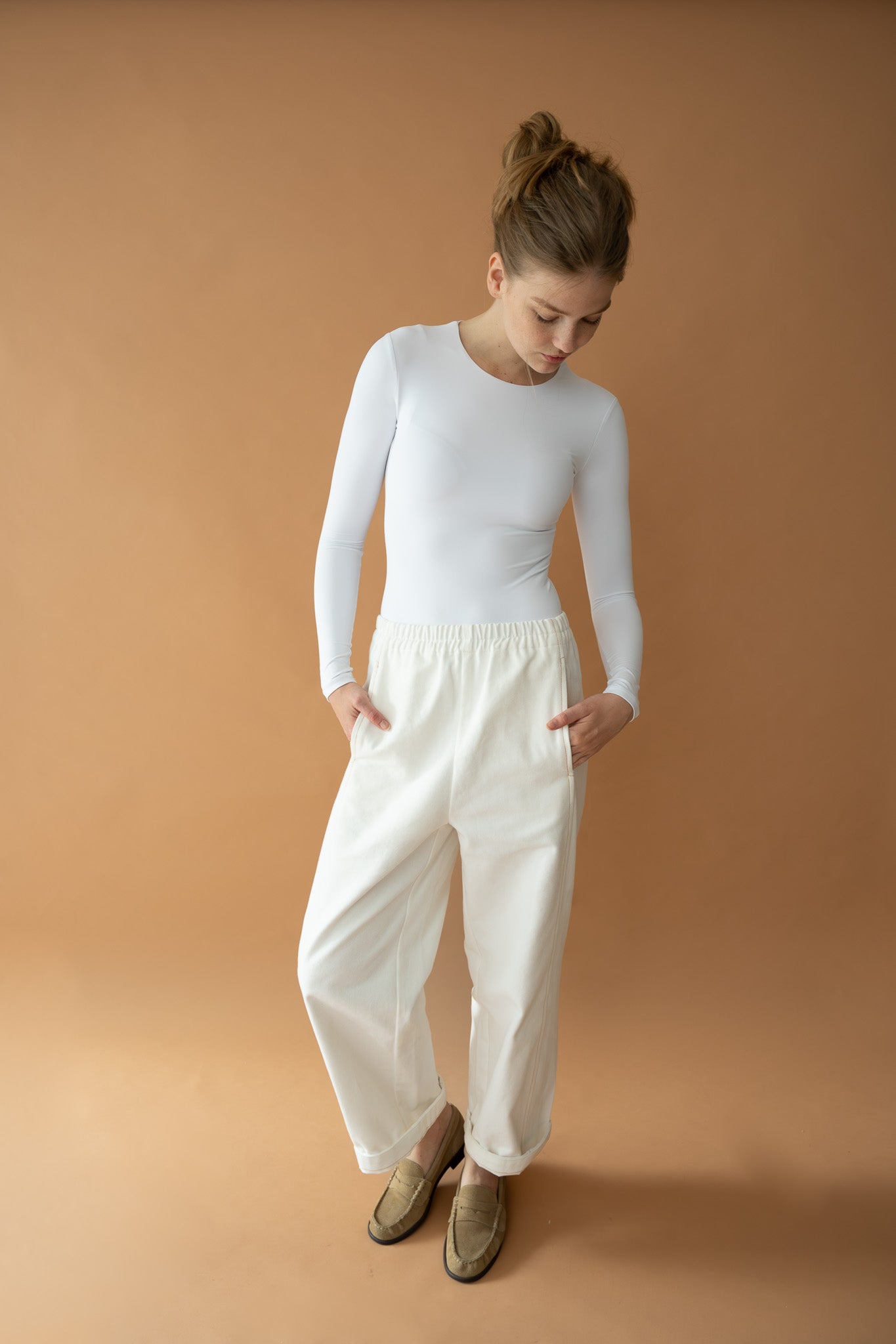 Model styling Blaze Jogger by The Boy & I with hands in pockets, made from vanilla organic cotton suede twill