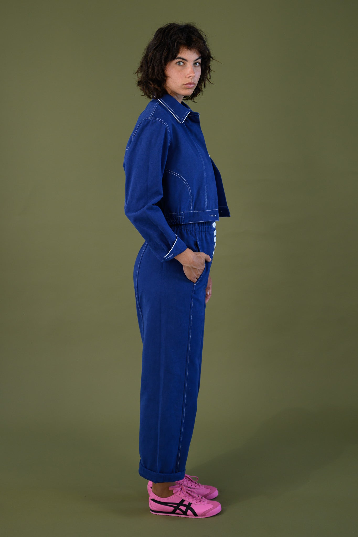 Blue cropped cotton twill jacket styled with matching pants shown full body