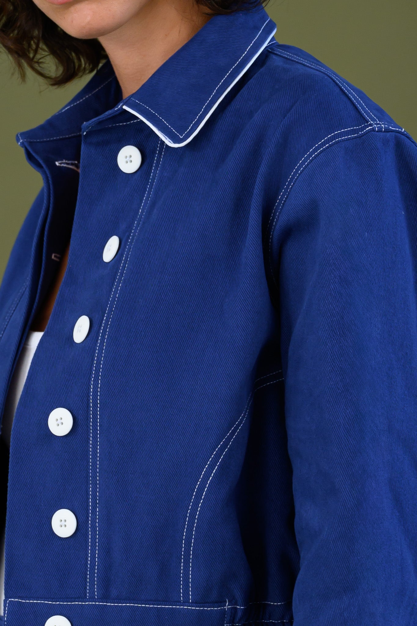 Close up of blue cotton twill fabric showing texture and stitching