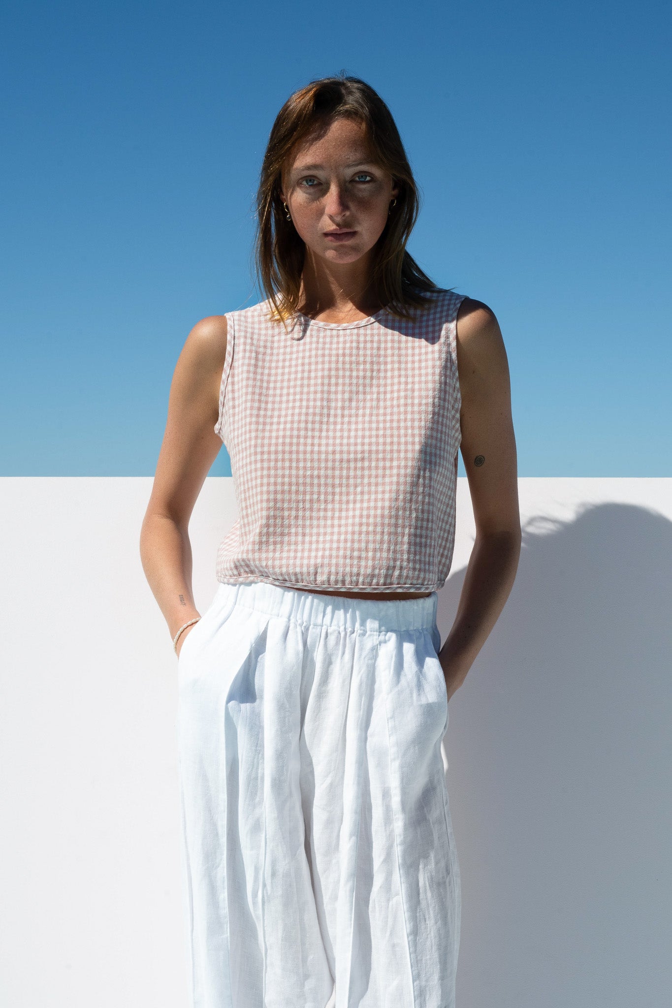 Close-up front view of The Boy & I Box Crop Top in blush gingham cotton linen blend