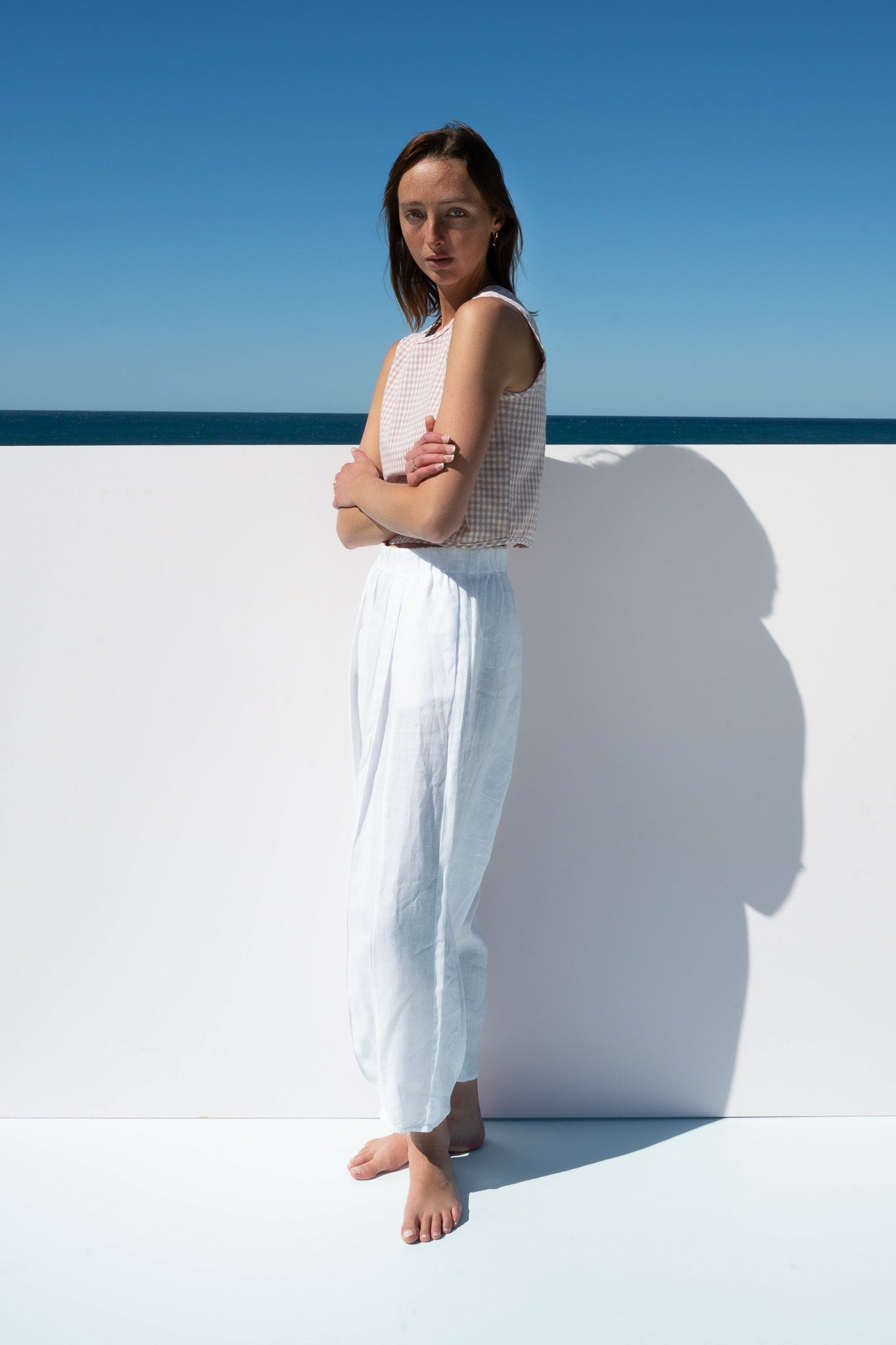 Side profile of The Boy & I Box Crop Top in blush gingham styled with relaxed salt pants in linen