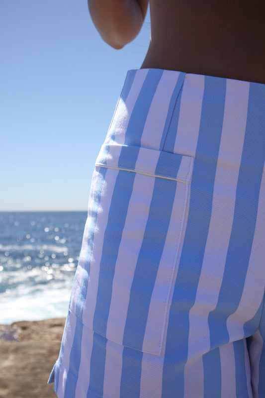 Close up of Calippo Short in sky blue stripe highlighting white piping on back pocket