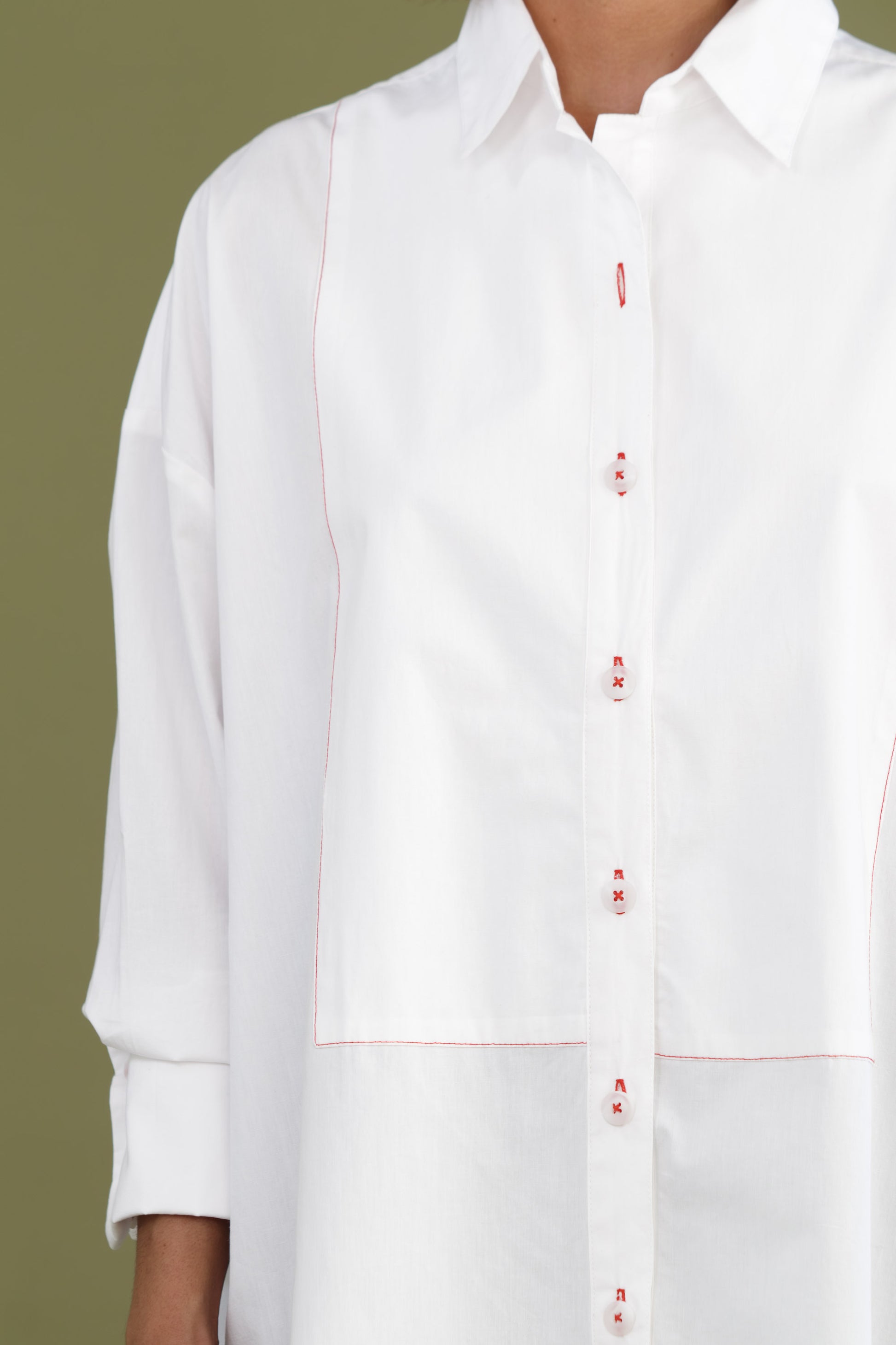 Close up of womens white boyfriend tux shirt in organic cotton poplin showing button front and contrast stitching detail