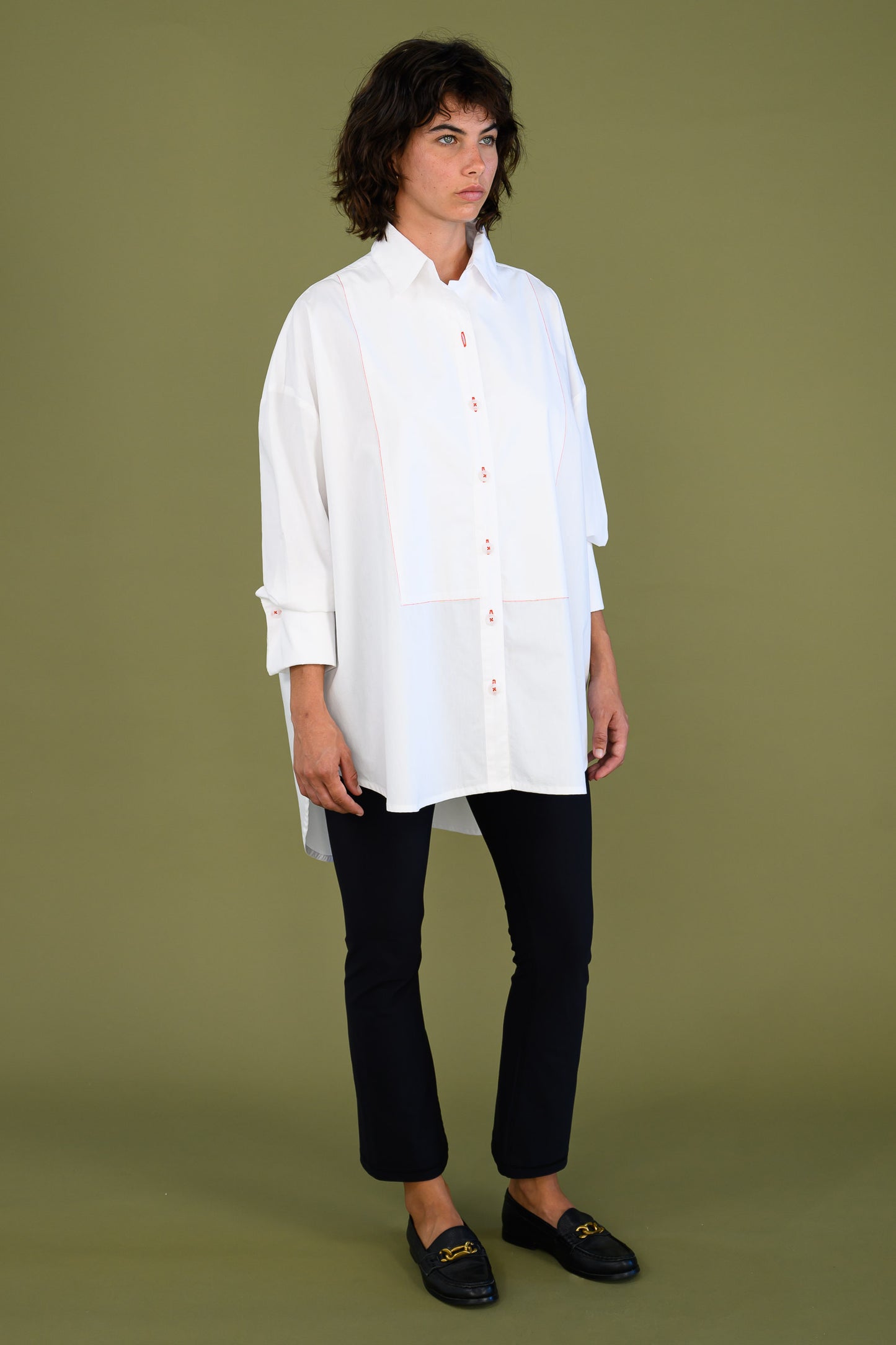 Womens oversized white boyfriend tux shirt in organic cotton poplin shown in angled front view highlighting relaxed fit and length