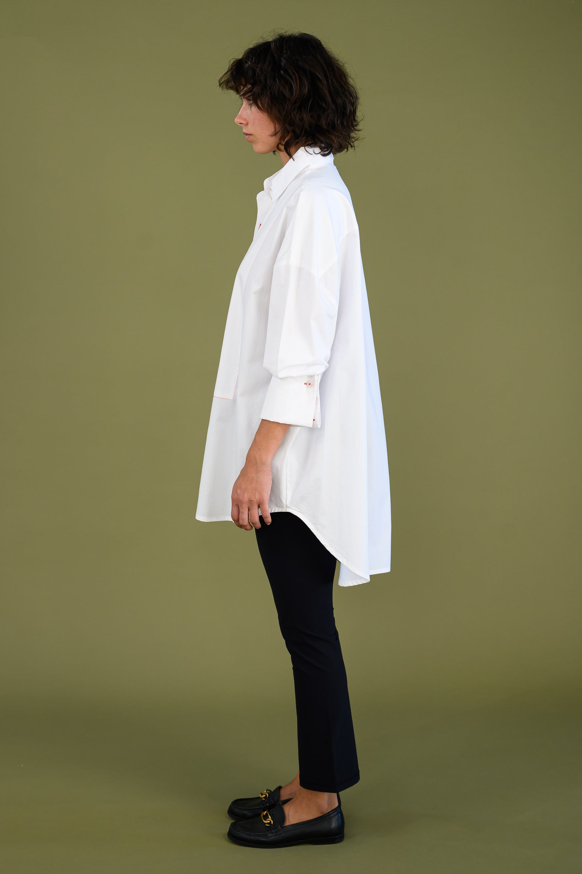 Womens oversized white boyfriend tux shirt in organic cotton poplin profile view showing clean silhouette and longline shape