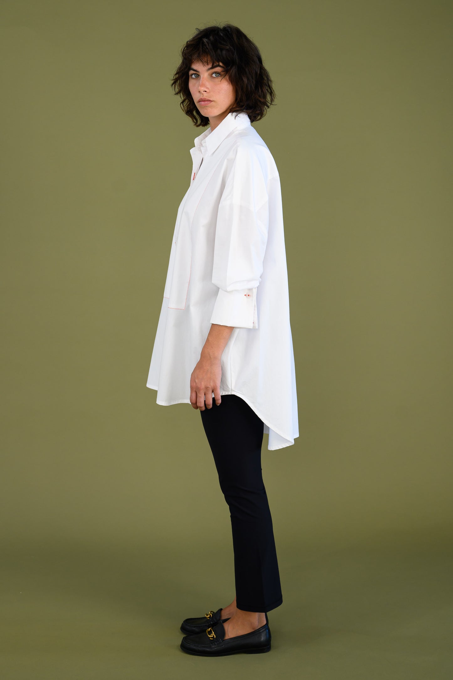 Womens oversized white boyfriend tux shirt in organic cotton poplin side view showing relaxed fit and longline silhouette