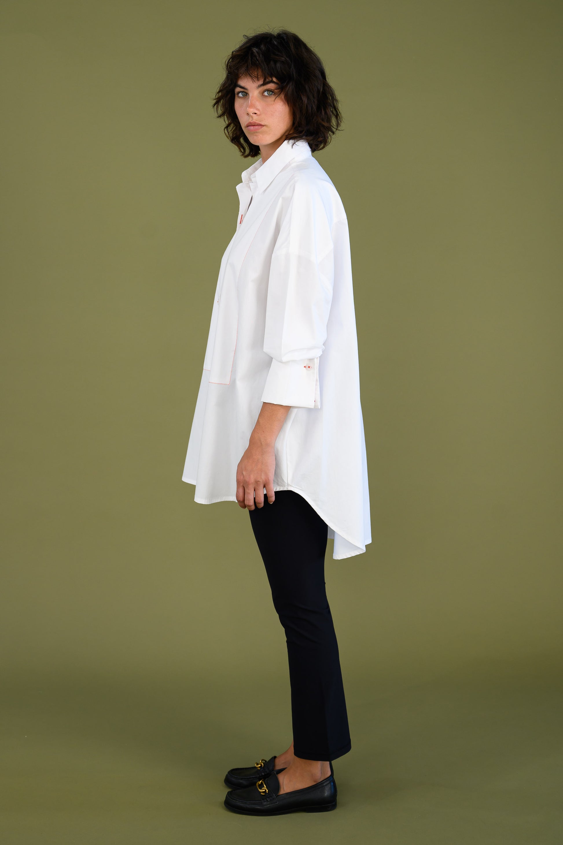 Womens oversized white boyfriend tux shirt in organic cotton poplin side view showing relaxed fit and longline silhouette