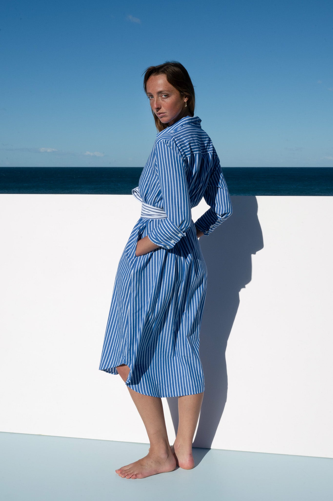 Side profile of The Boy & I Bronte Dress in blue and white pinstripe with relaxed silhouette