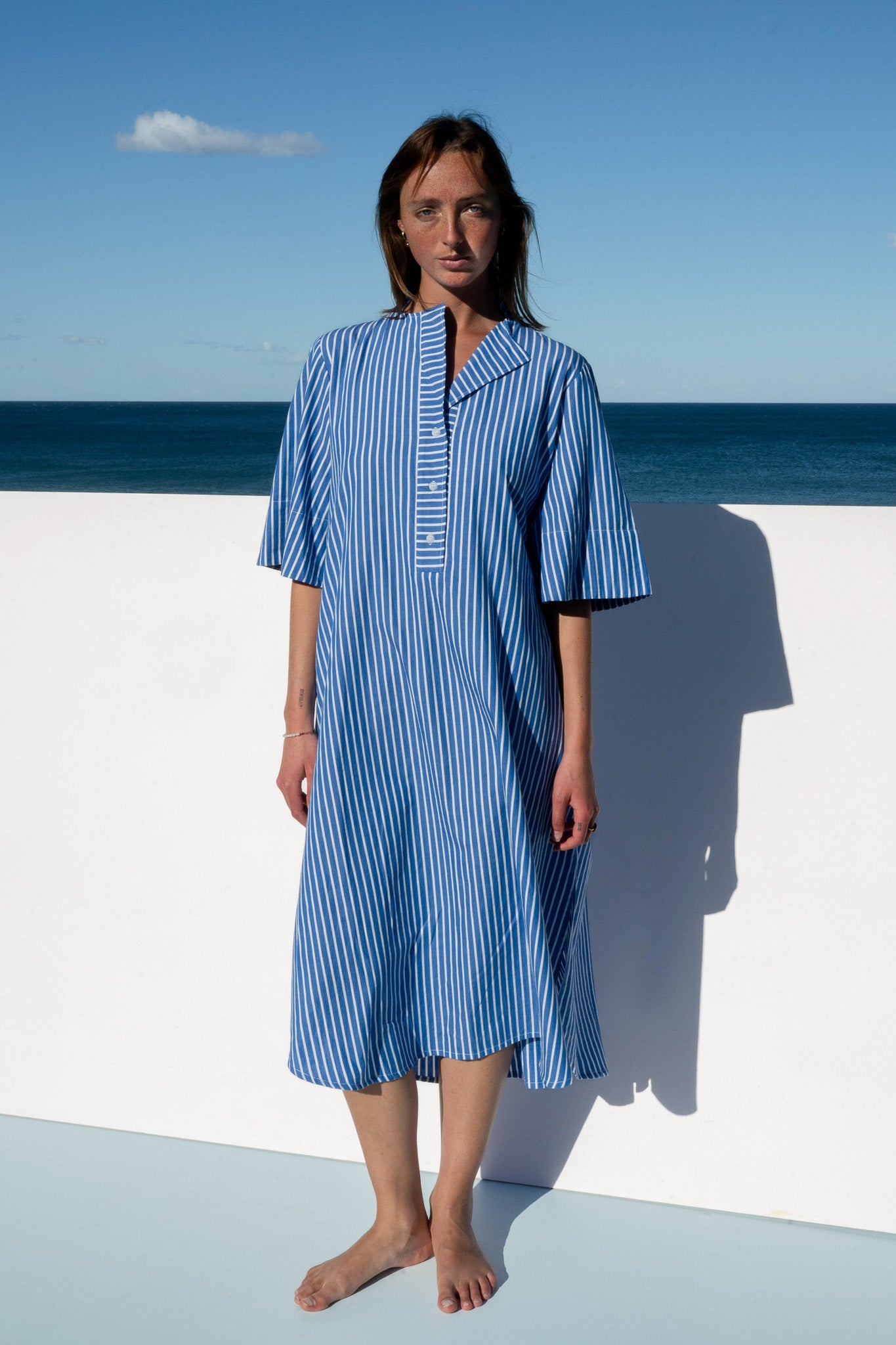 Front view of the Cabana Dress in 100% cotton blue stripe, relaxed oversized fit