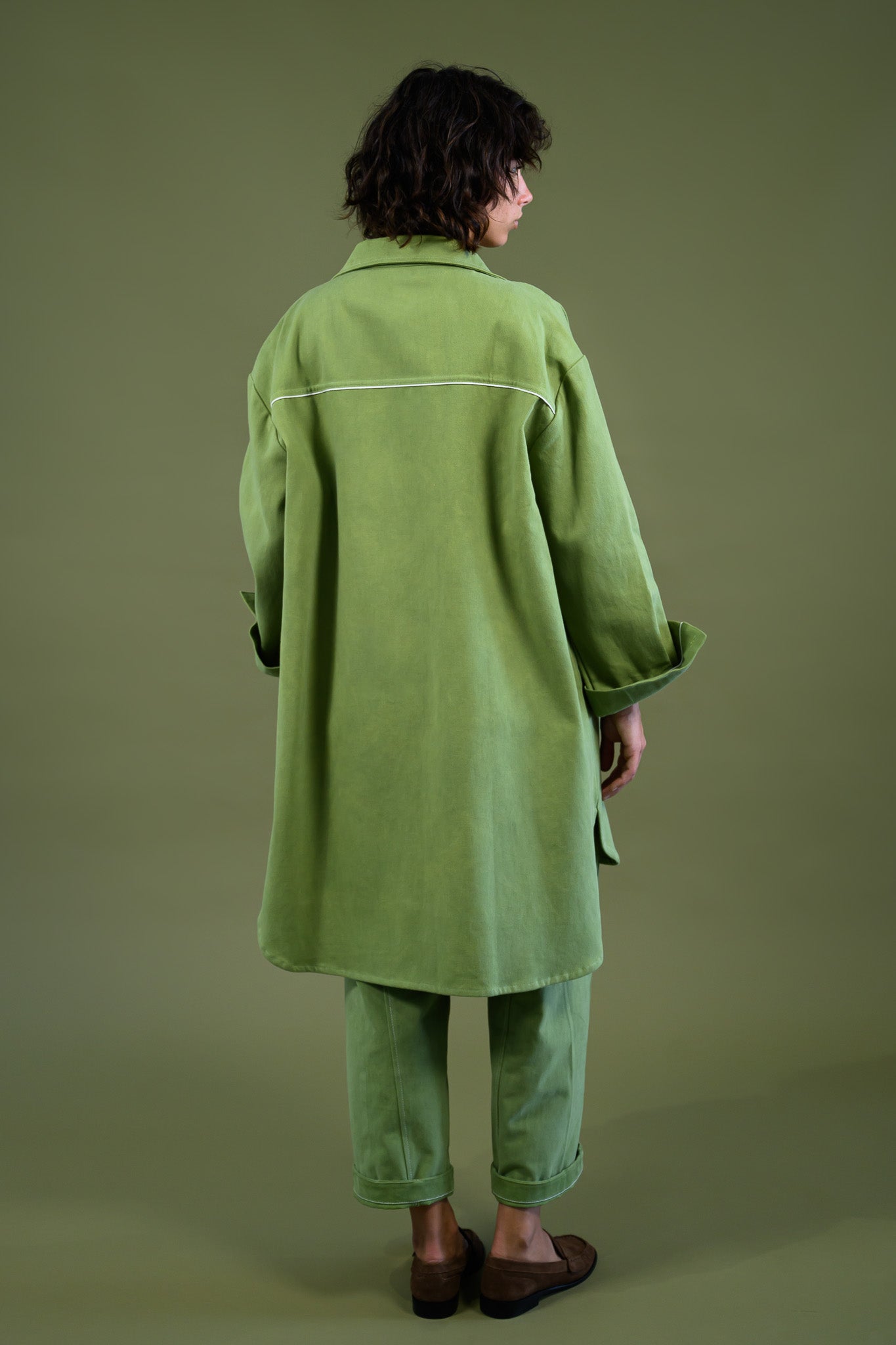 Womens field green canvas denim jacket back view showing relaxed fit and longline silhouette