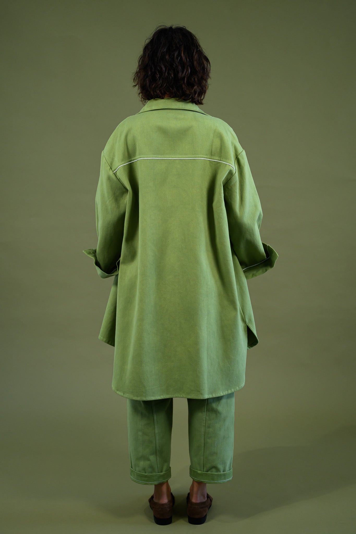 Womens field green canvas denim jacket back view showing relaxed fit and longline silhouette