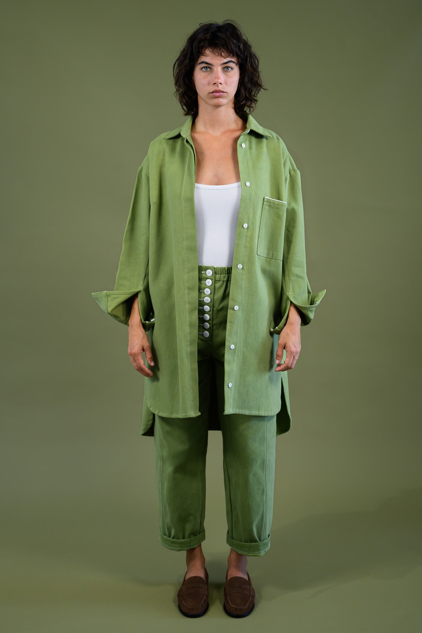 Womens field green canvas denim jacket front view showing relaxed fit and longline silhouette
