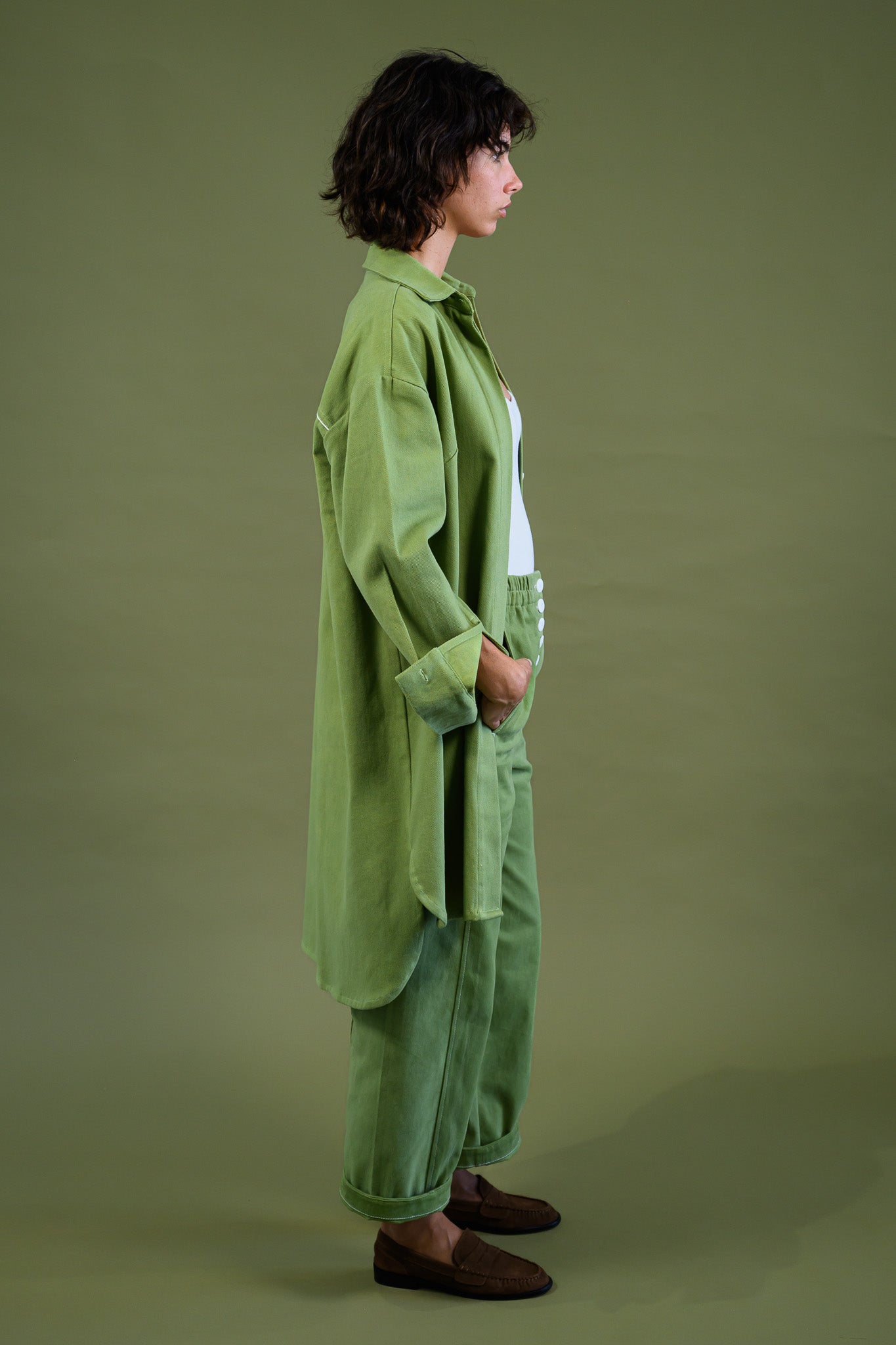 Womens field green canvas denim jacket side profile showing longline relaxed fit and drape
