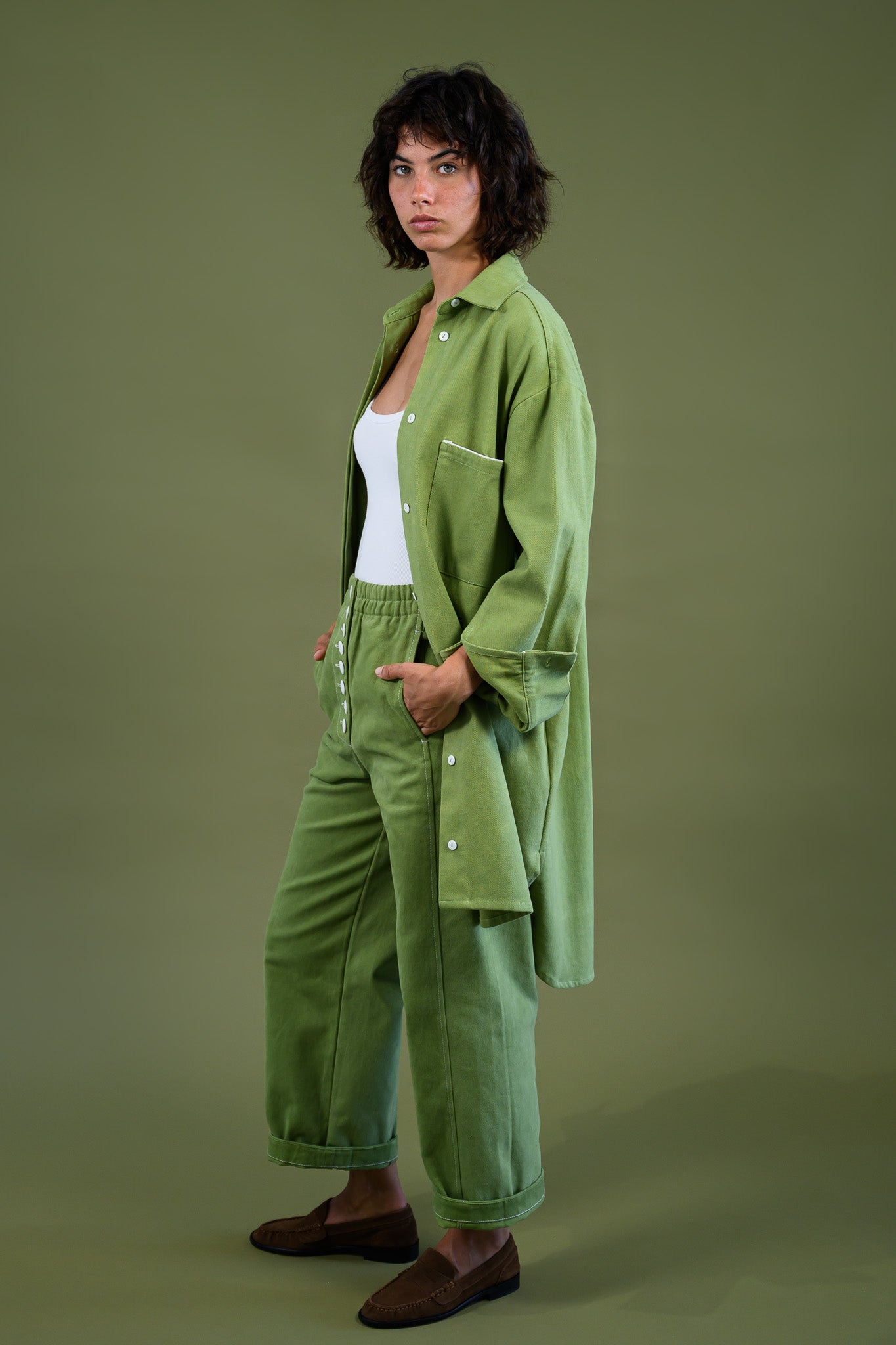 Womens field green canvas denim jacket three quarter view showing relaxed fit and drape