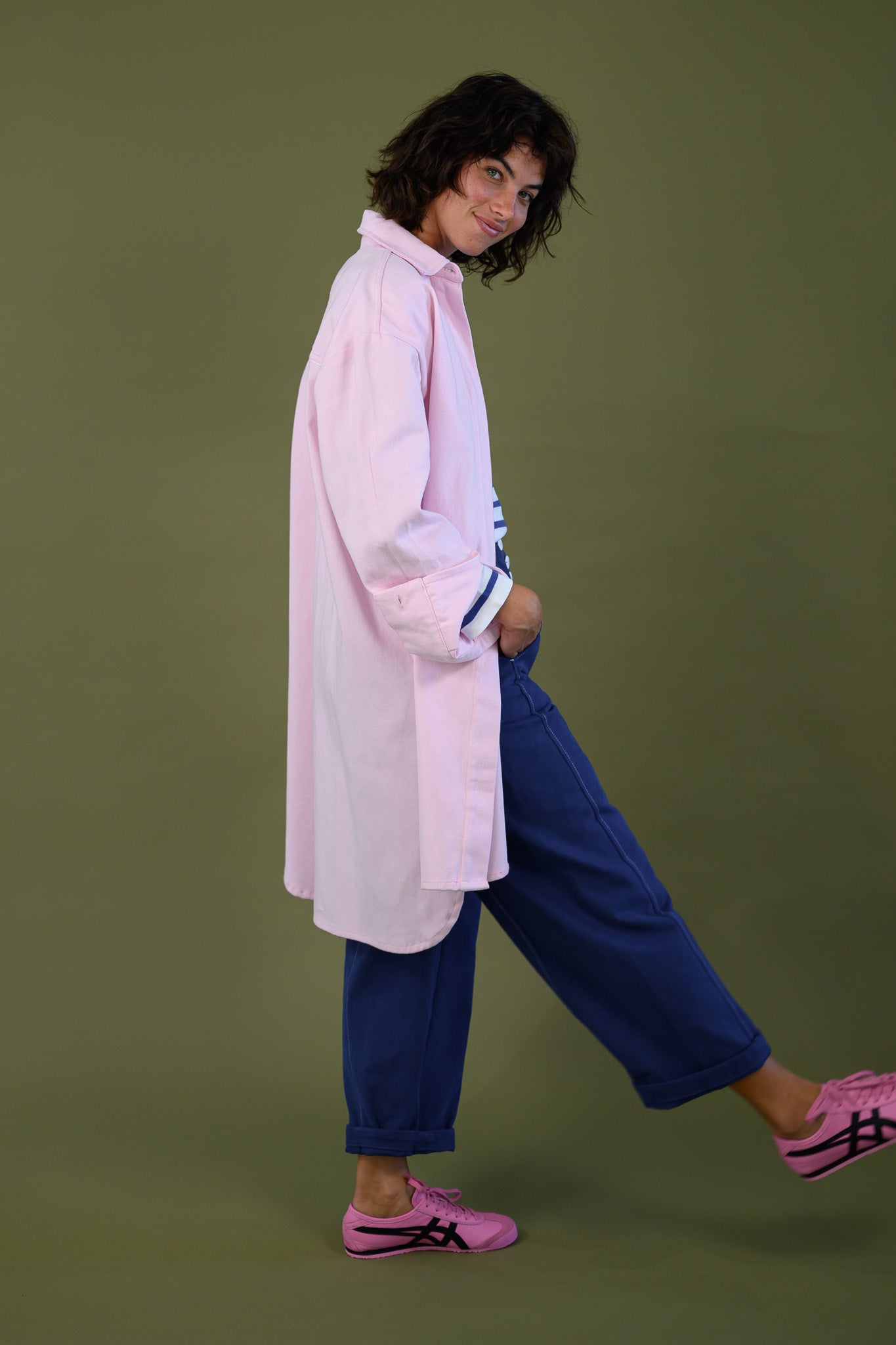 Womens pink canvas denim jacket styled in a casual outfit side view walking relaxed everyday look