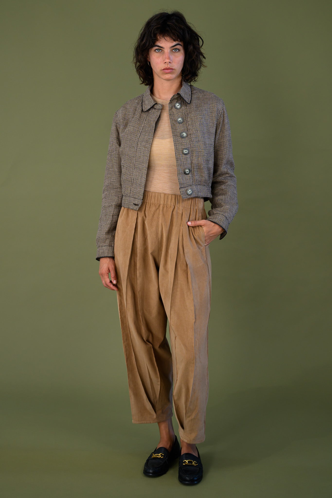 Cropped check jacket styled with relaxed pants showing full outfit and proportion