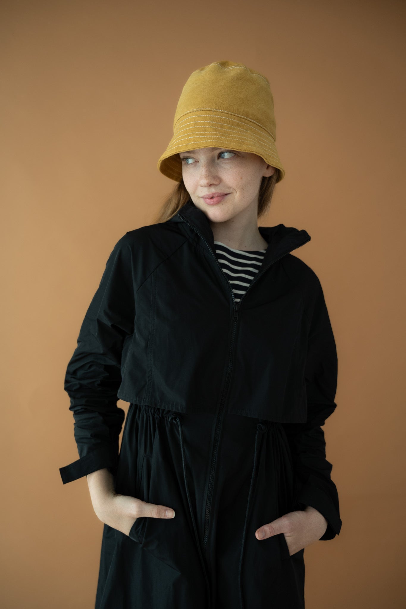 Close-up of Cloud Breaker raincoat drawcord waist and front zip detail