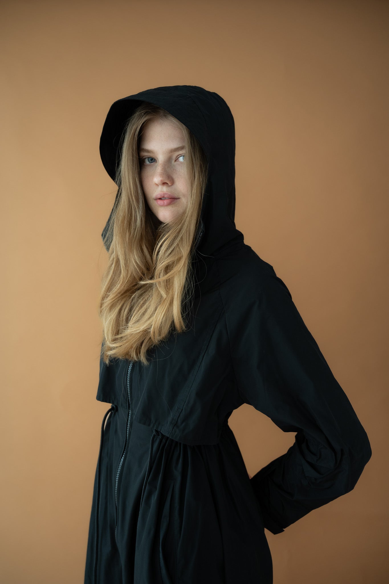 Cloud Breaker raincoat with hood on, highlighting lightweight technical taffeta design