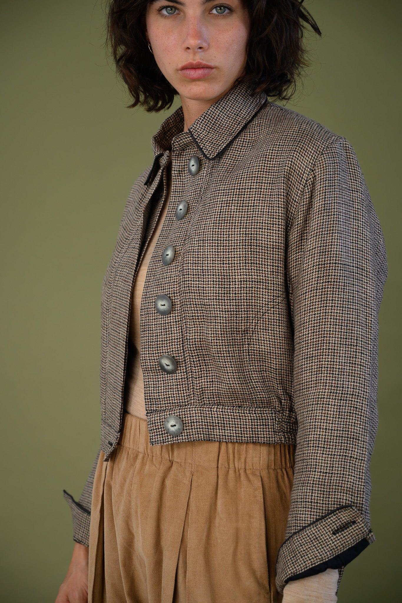 Cropped check jacket front view showing button detail and tailored fit